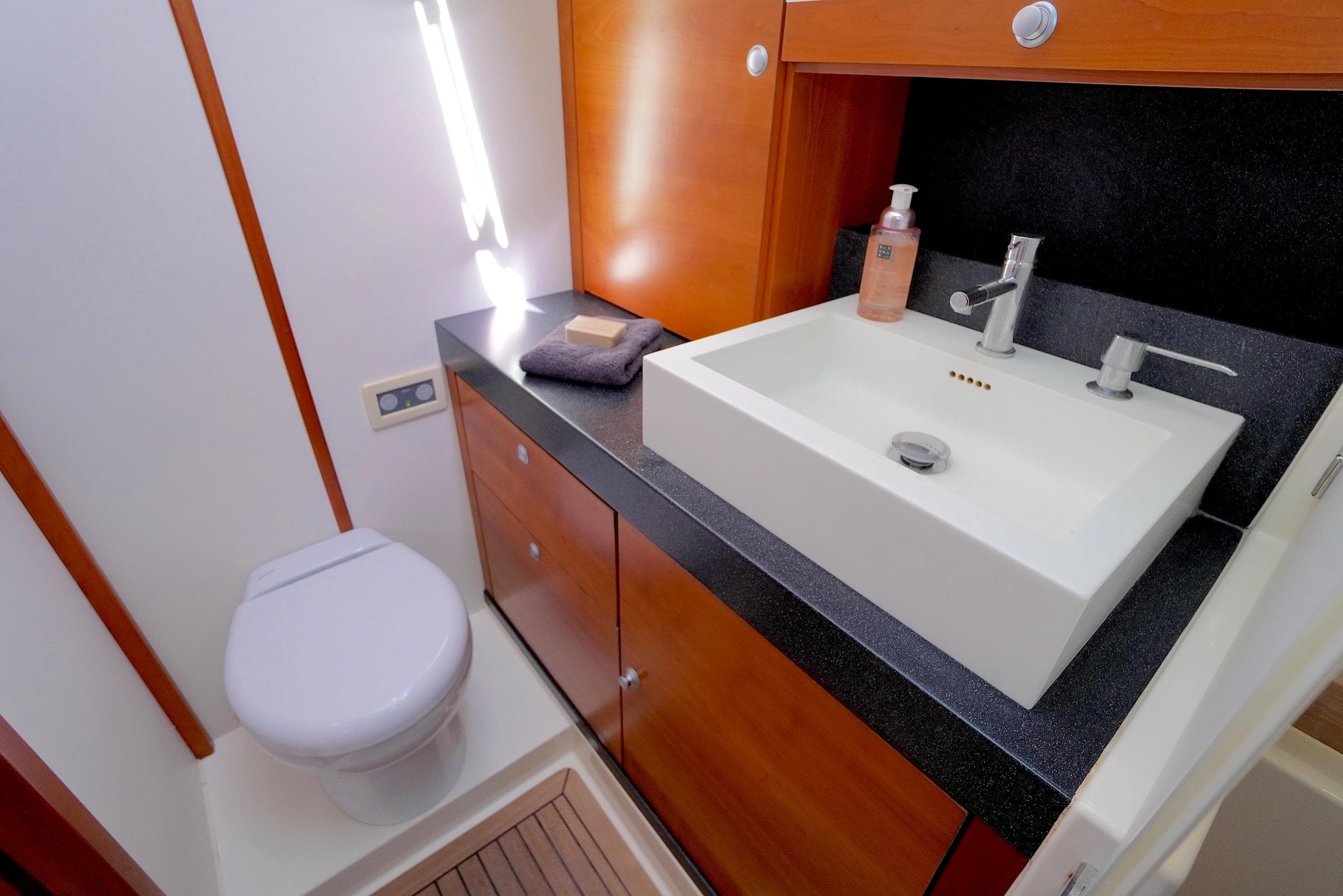 Luxurious bathroom in 2009 Hanse 630e yacht with modern sink and toilet.