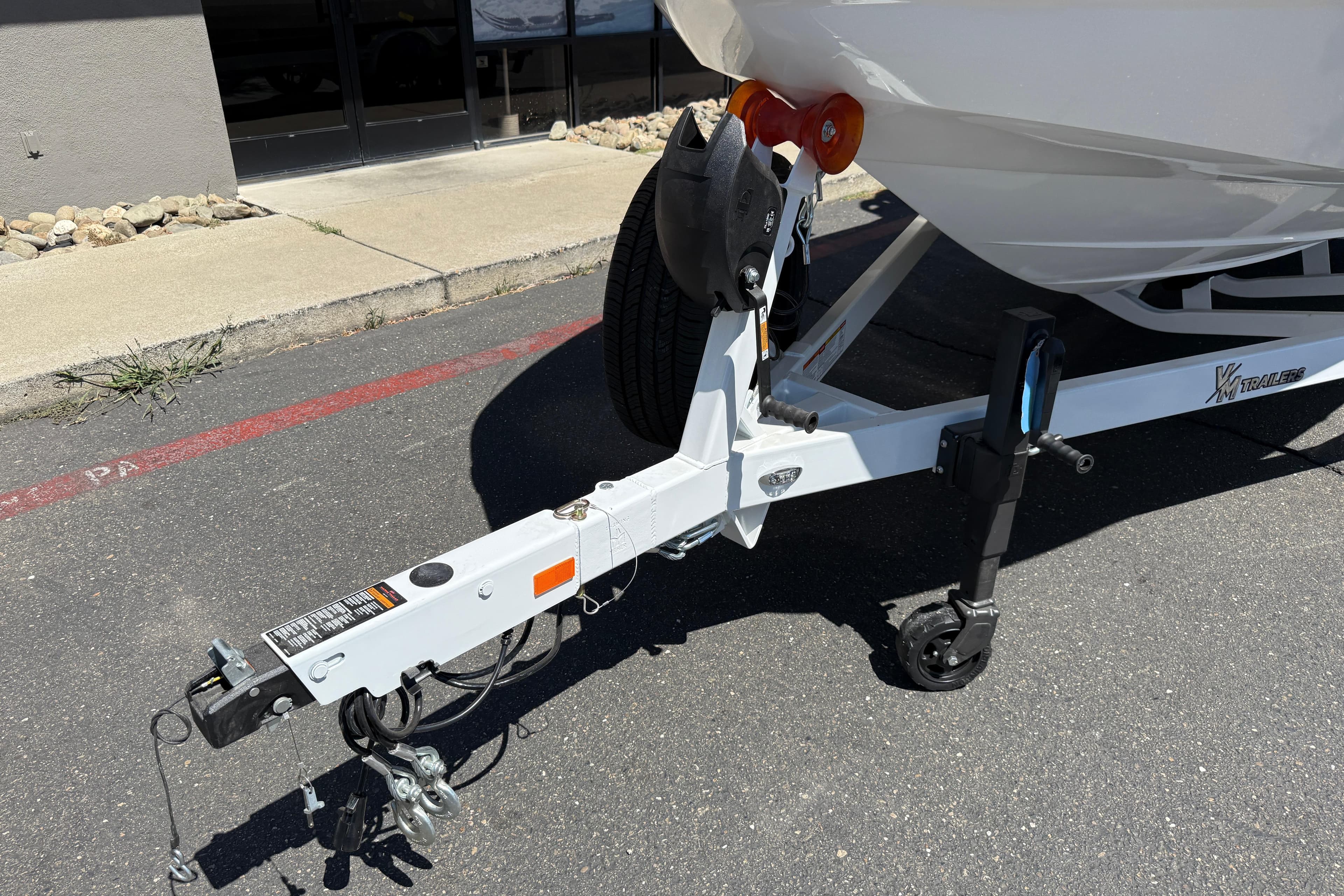 Trailer hitch of 2026 MB B52 23 Alpha boat on pavement.