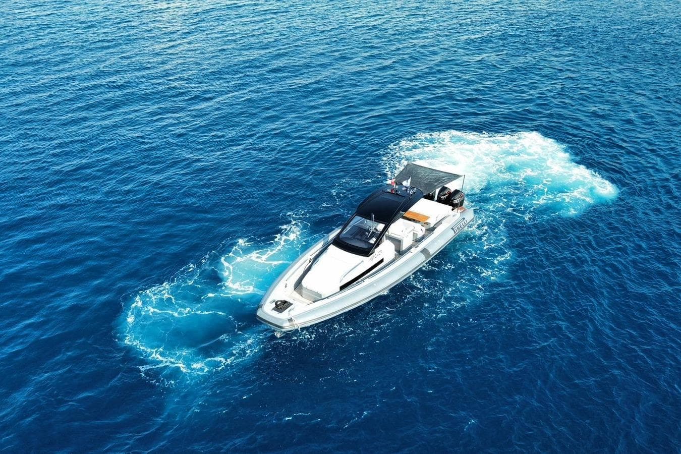 2023 Pirelli 42 boat cruising on clear blue ocean waters.