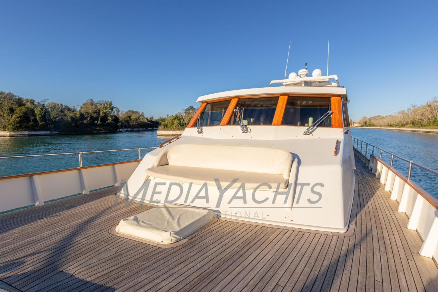 Luxury yacht AZZURRO 20 on serene water, showcasing spacious deck and elegant design.