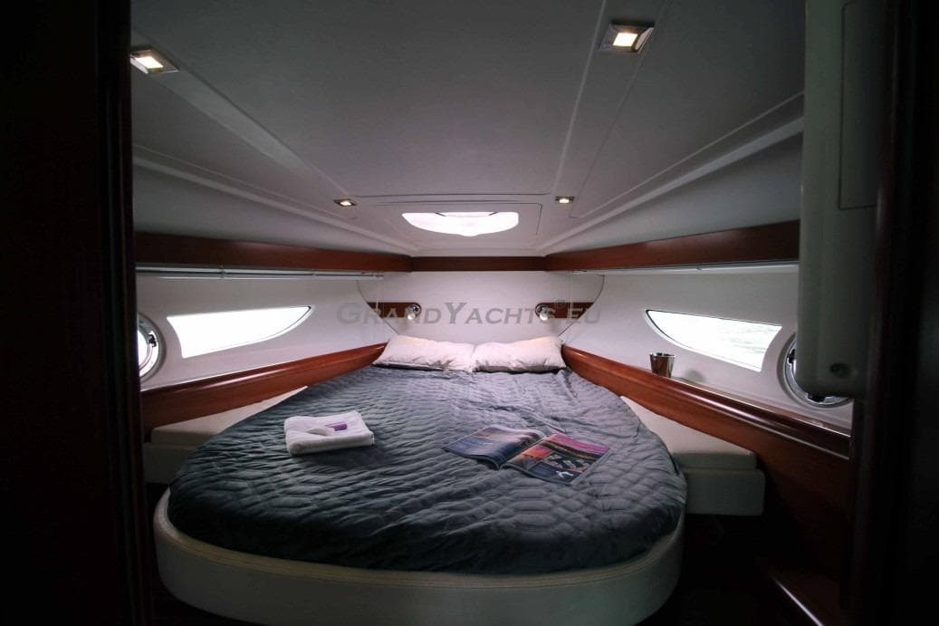 Luxurious cabin interior of 2011 Beneteau Gran Turismo 38 yacht with cozy bed.