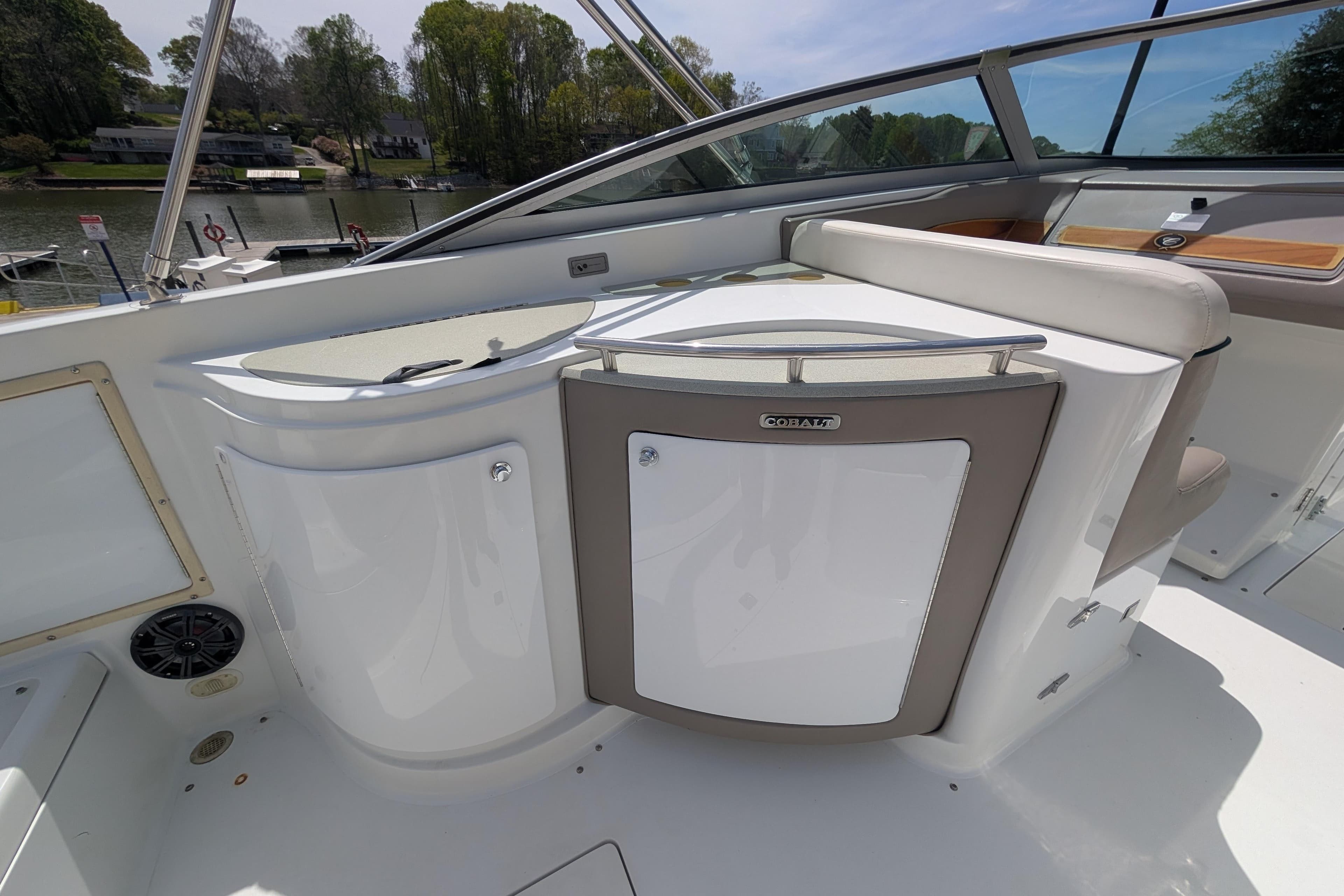 Interior of a 2000 Cobalt 292 boat, featuring sleek white seating and storage compartments.