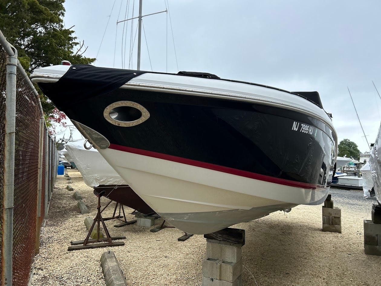 2010 Cobalt 262 boat on blocks in a marina storage area.