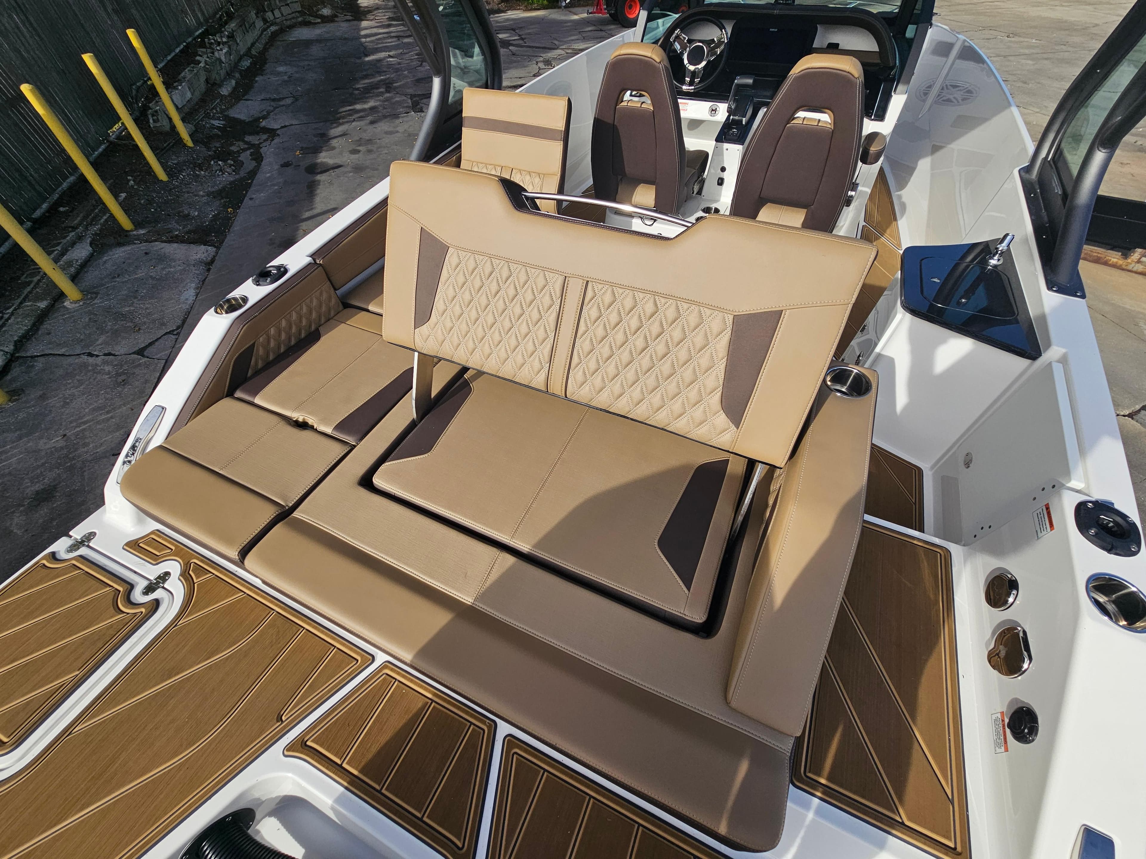 2025 Monterey Elite 27 OB boat interior with tan seating and modern design.