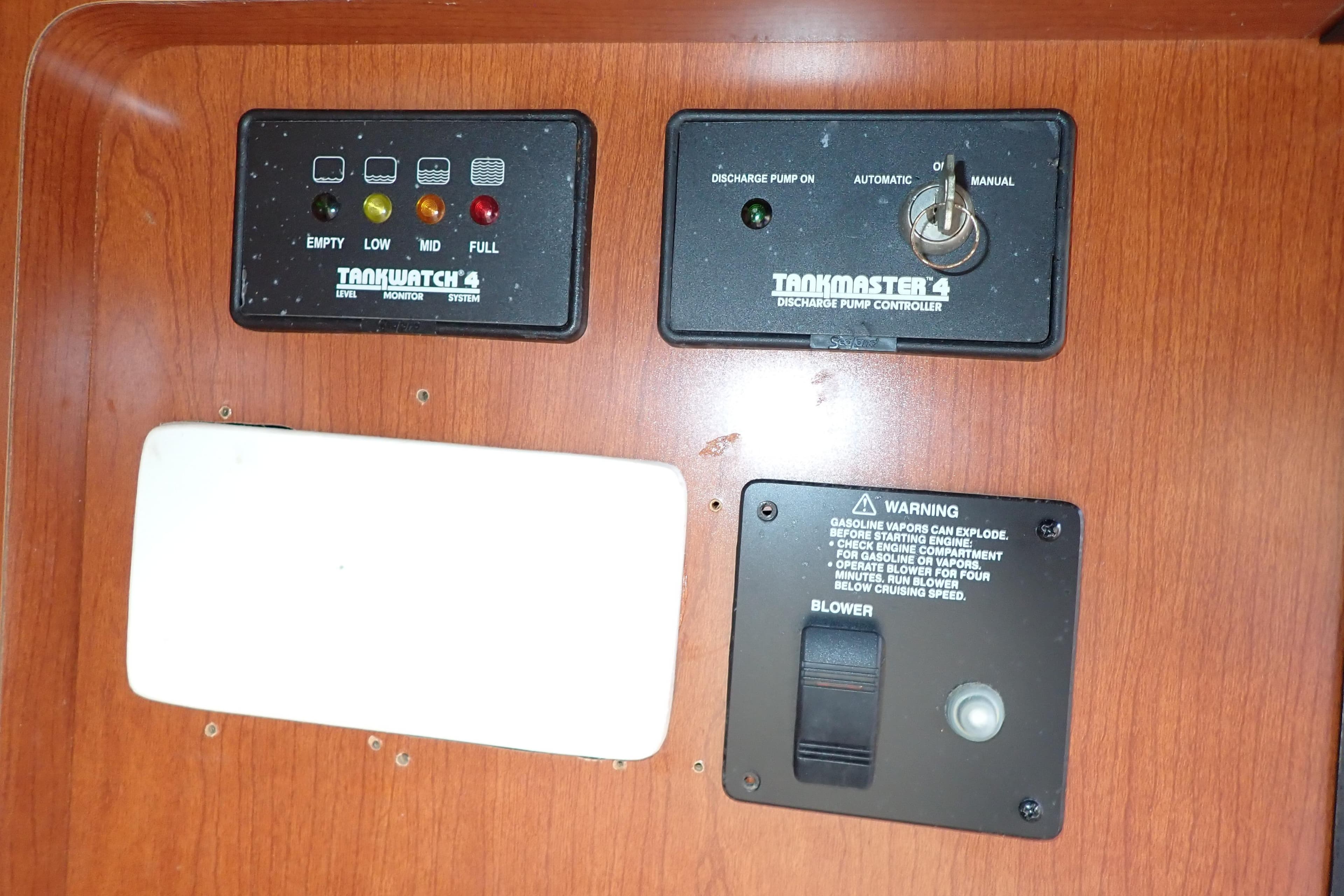 Control panel of a 2014 Pro-Line 32 Express boat with tank monitor and pump controller.