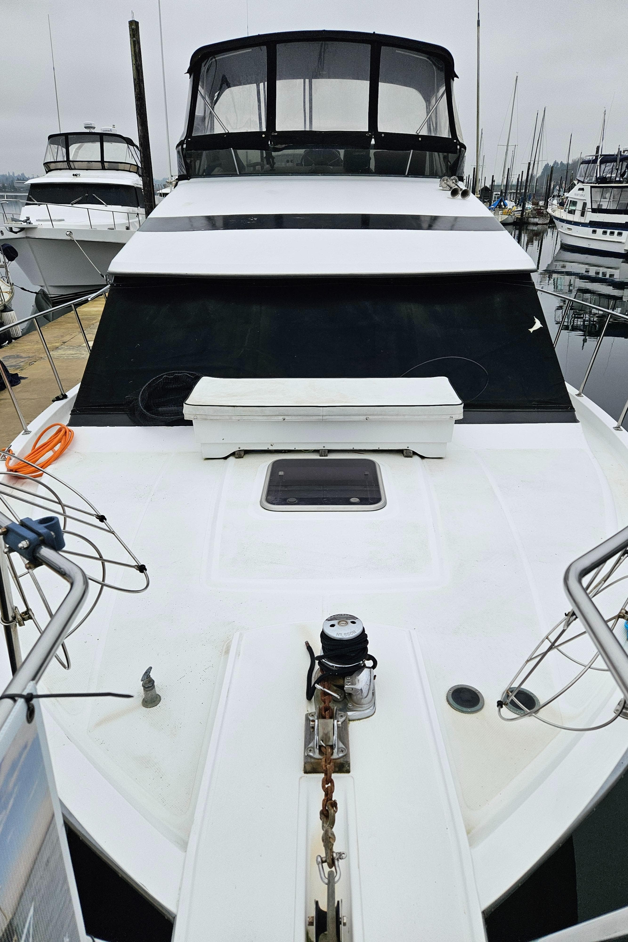 1991 Tollycraft Euro Sport Sedan yacht docked at marina, front view.