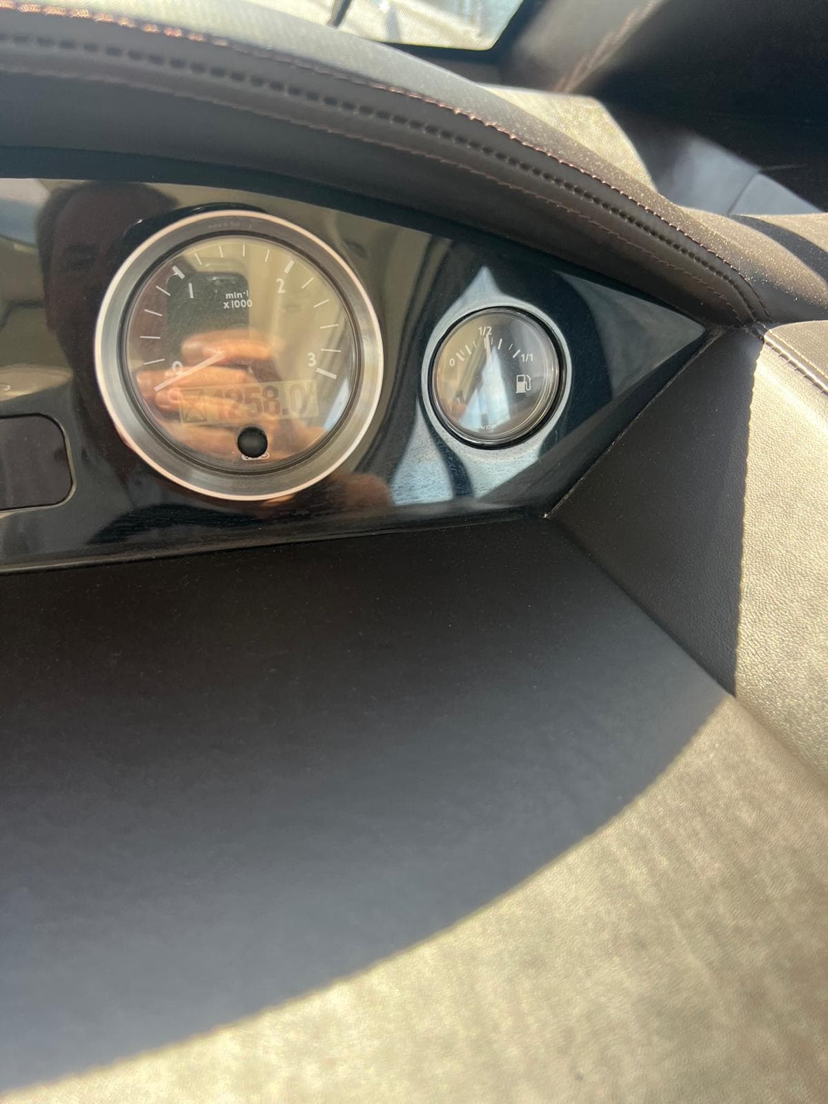 Dashboard of a 2011 Princess V62 yacht, featuring gauges and leather trim.