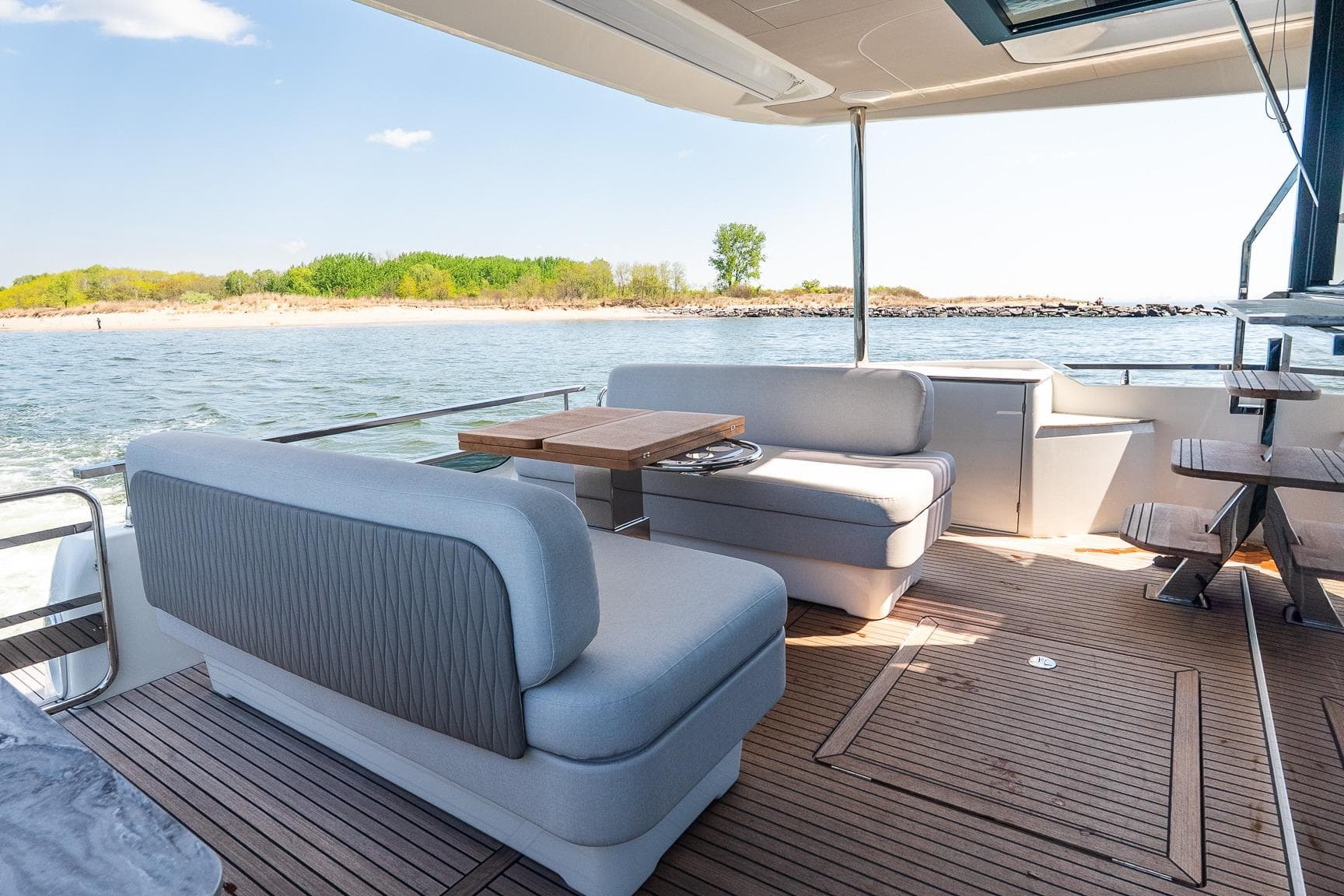 Luxurious Prestige F5.7 yacht interior, 2026 model, featuring elegant seating and scenic ocean view.