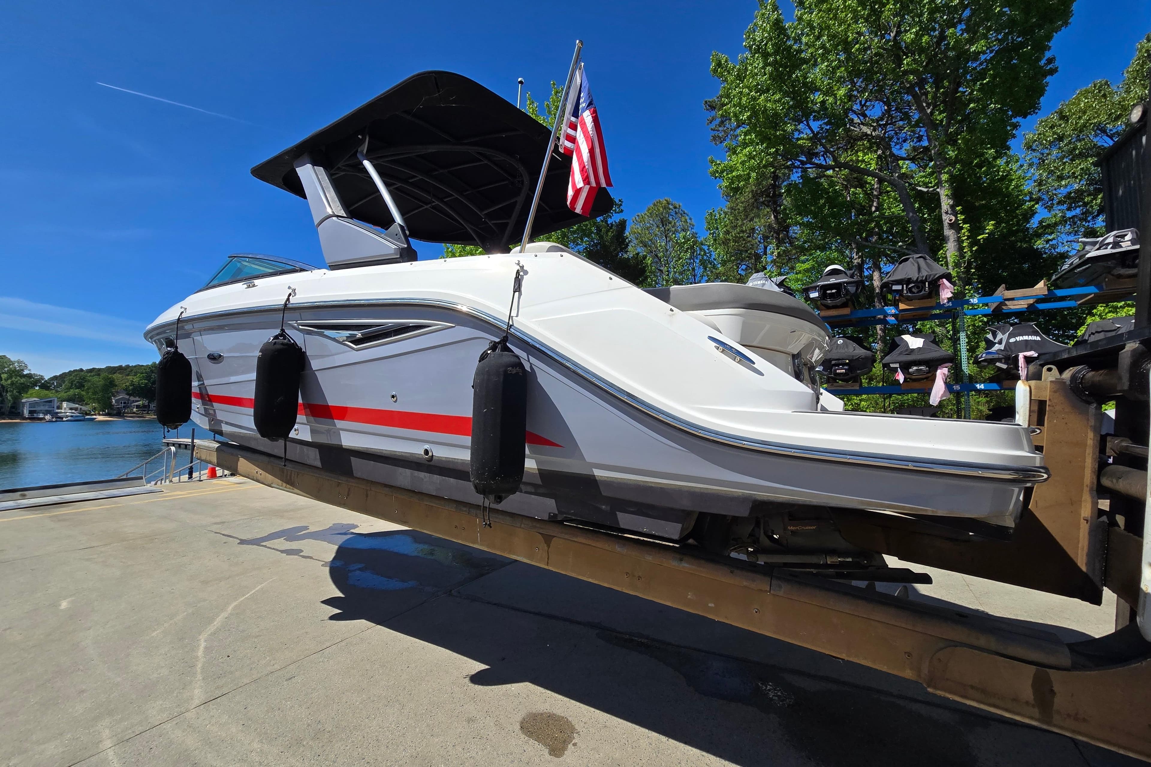 2022 Sea Ray SLX 280 boat on trailer, dockside with American flag, sunny day.
