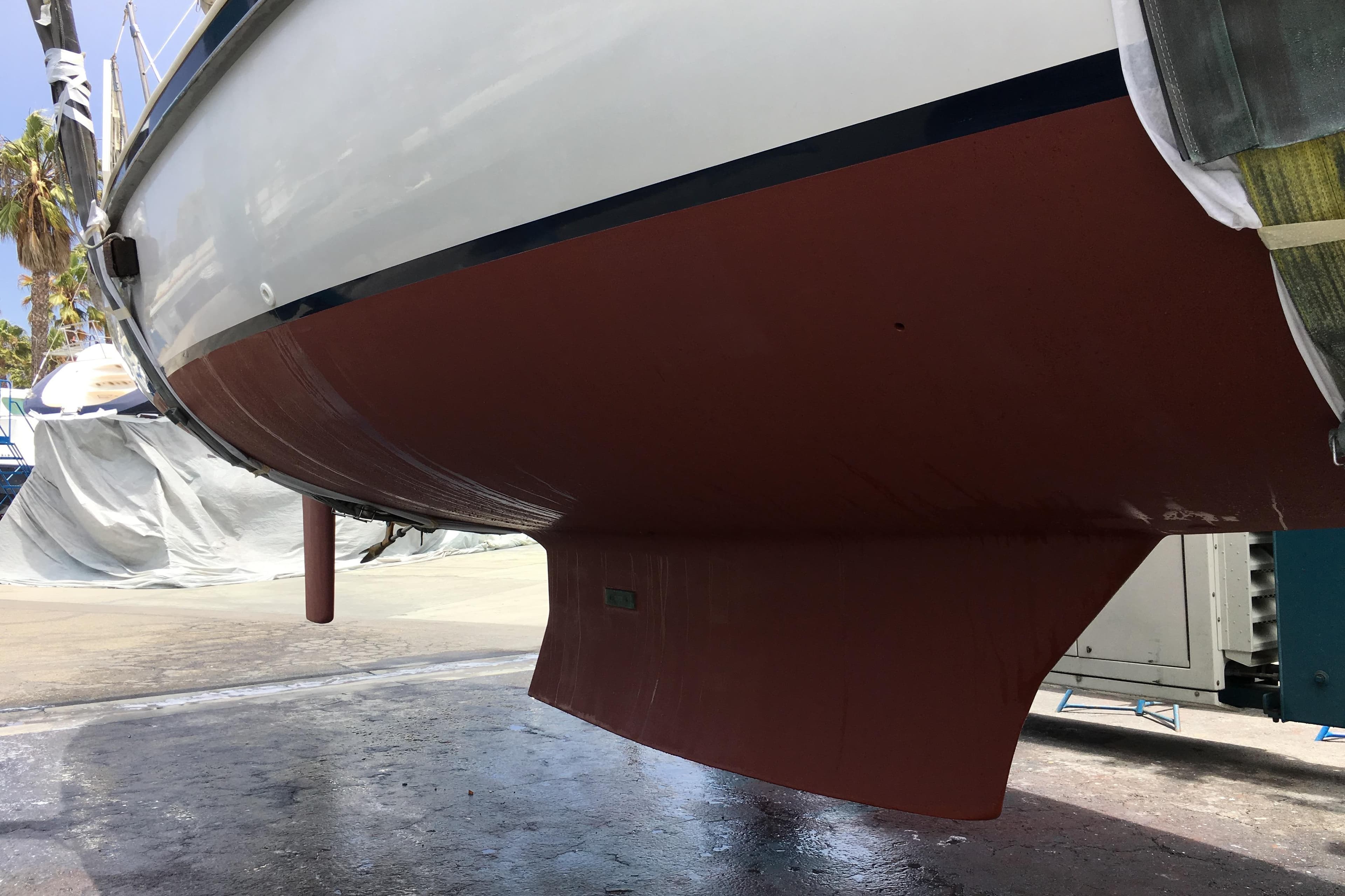 1989 Nonsuch 36 sailboat hull in dry dock, showcasing its sleek design and keel.