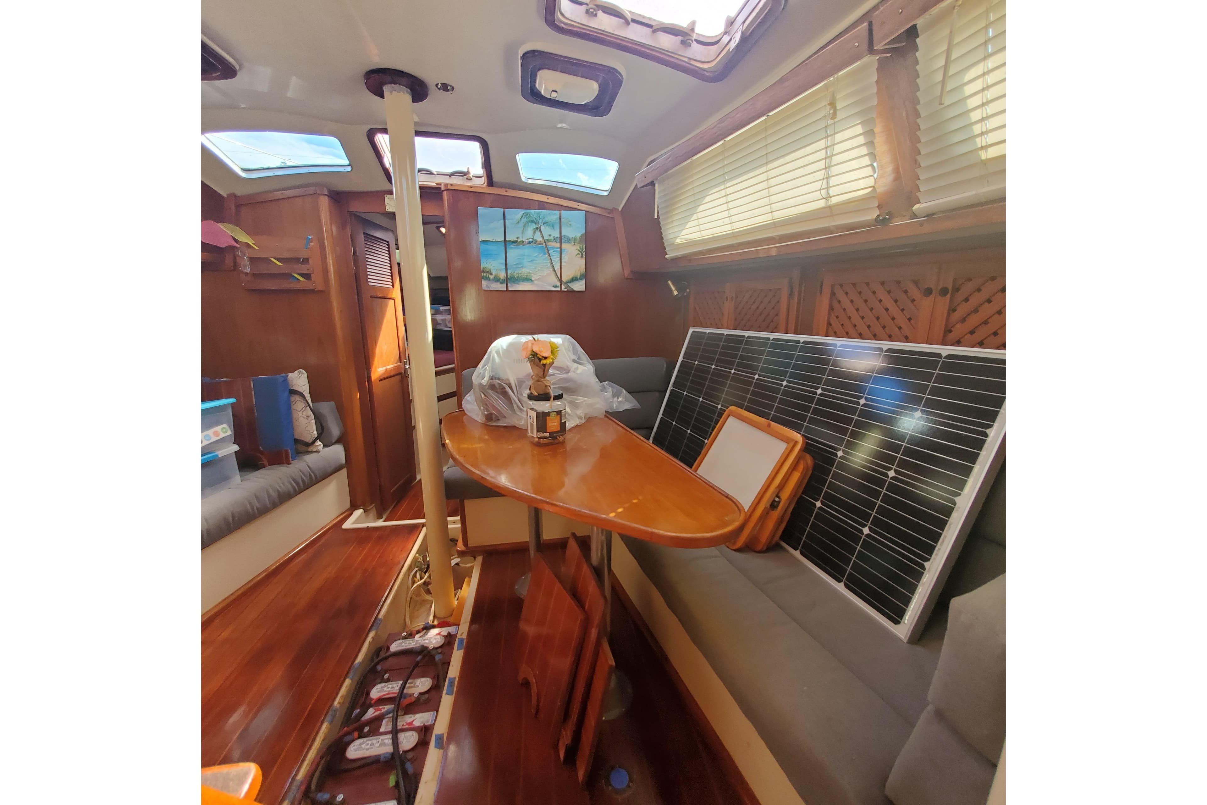 Interior of 1987 Irwin 38 Mk II sailboat with solar panel and wooden furnishings.