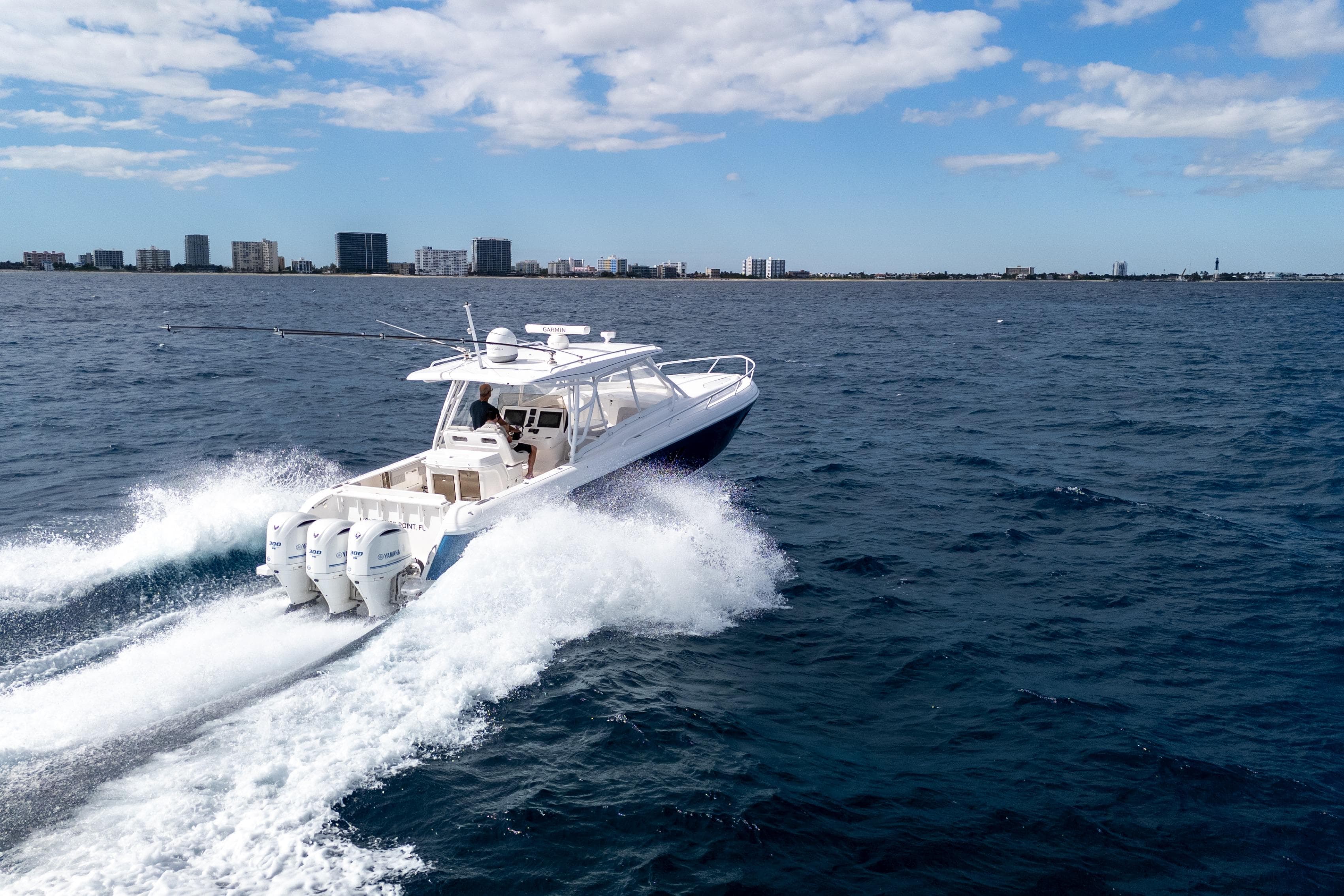 2019 Intrepid 407 Cuddy cruising on open water under a clear sky.
