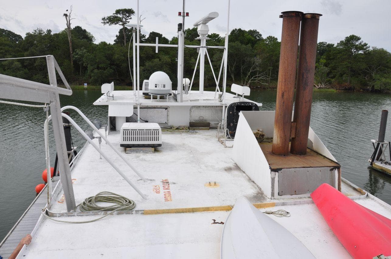 Rodriquez 50 Pilothouse boat deck, 1999 model, with equipment and scenic water background.