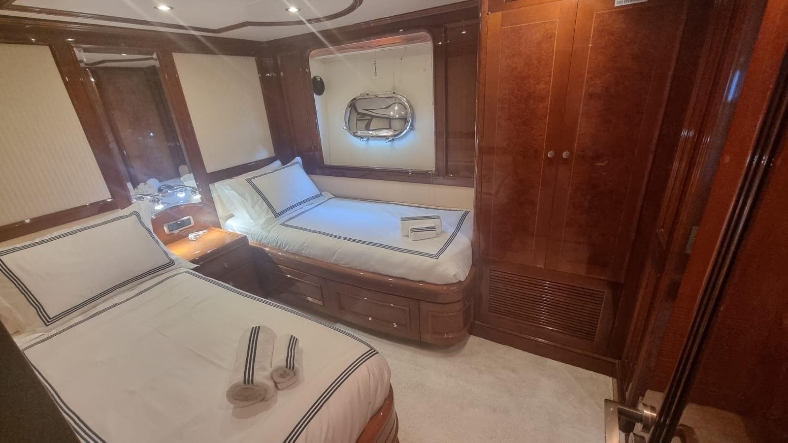 Luxurious cabin interior of 2000 Benetti Classic 115 yacht with twin beds.