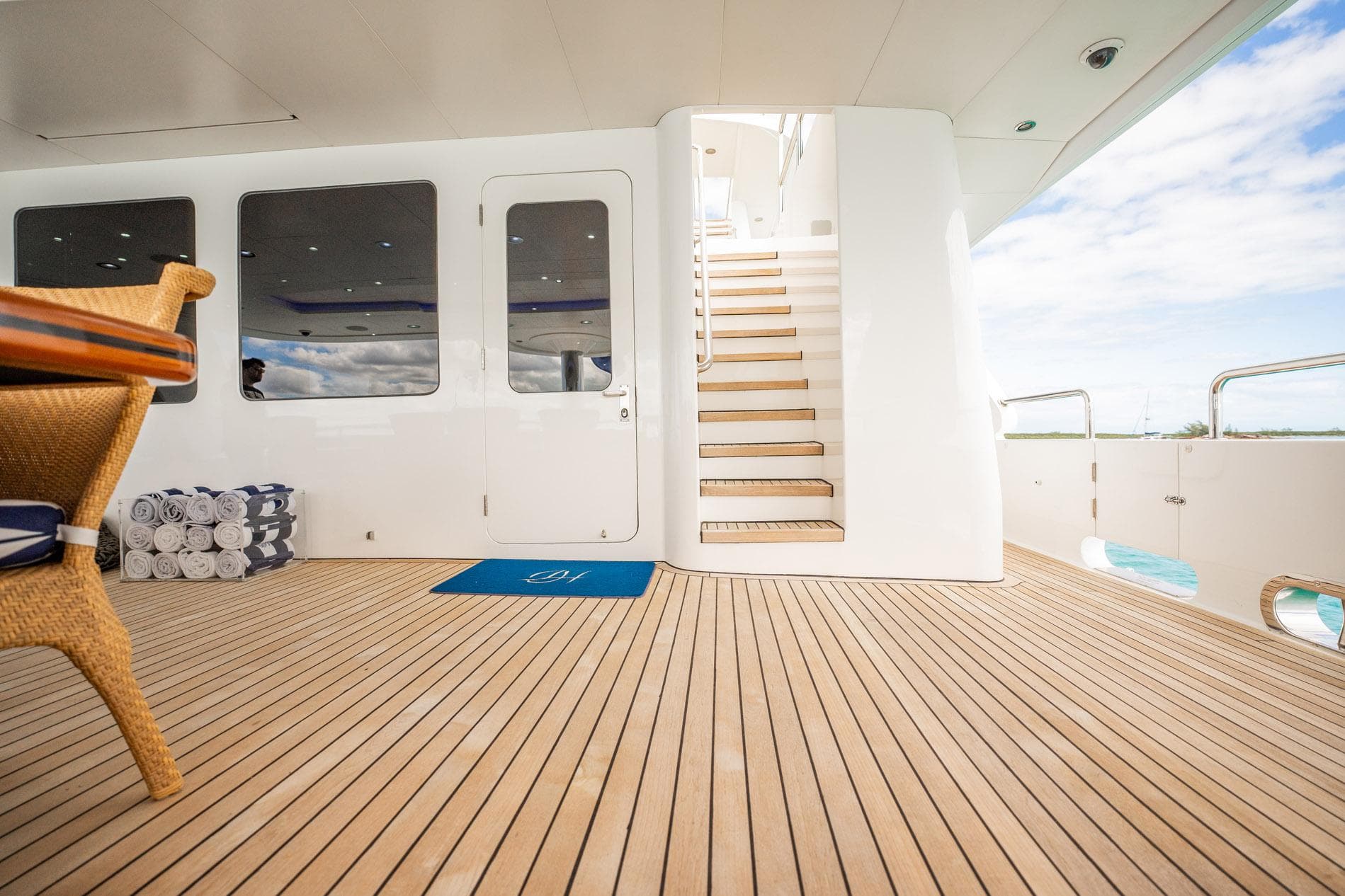 Luxurious deck of 1996 Cheoy Lee 145 Global Series yacht with wooden flooring and staircase.