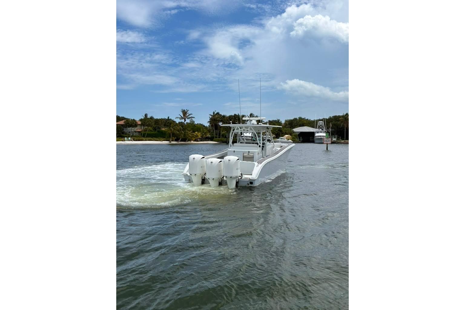 2014 Yellowfin 42 Offshore boat cruising on a scenic waterway.