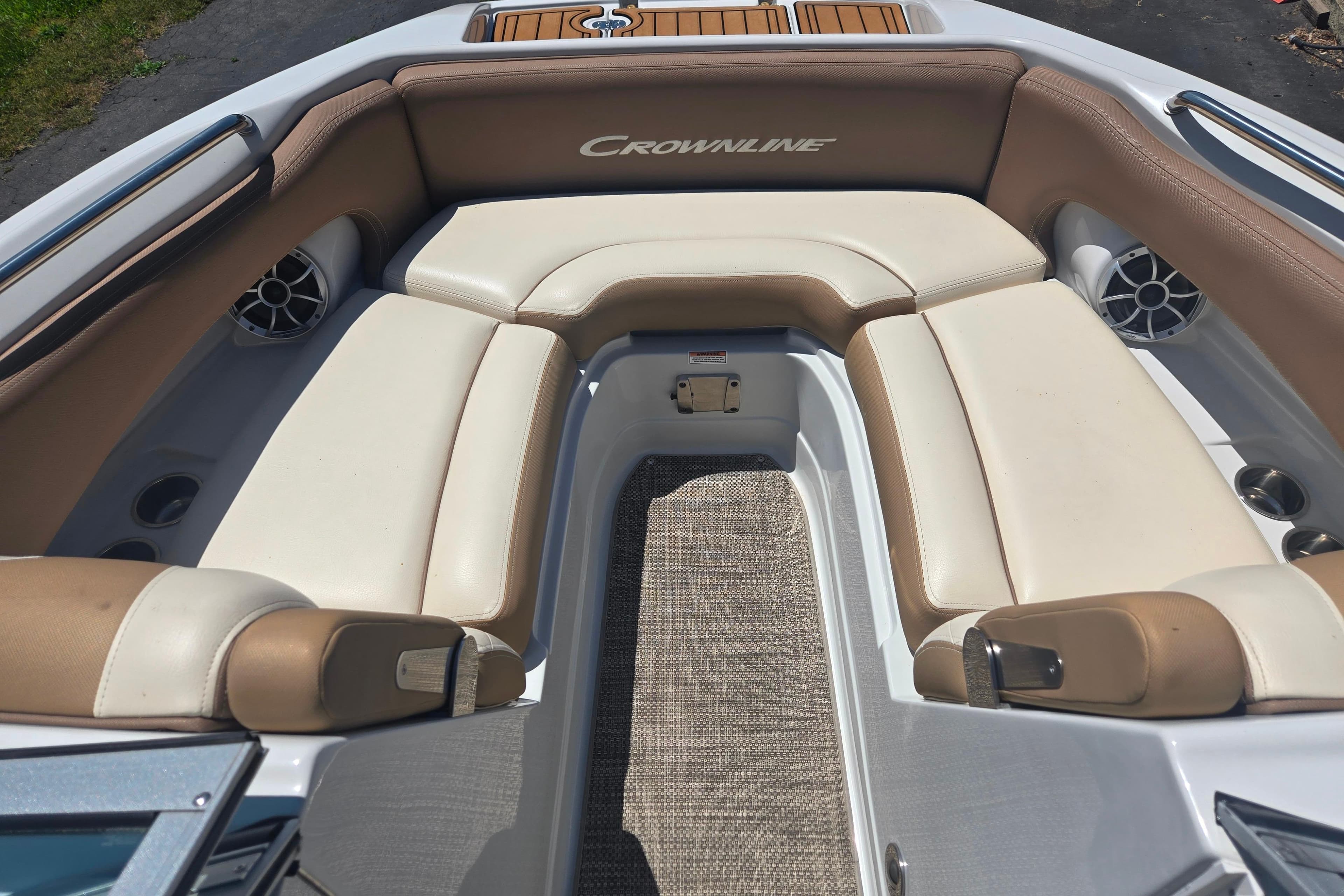 2021 Crownline Eclipse E235 boat interior with beige seating and carpeted floor.