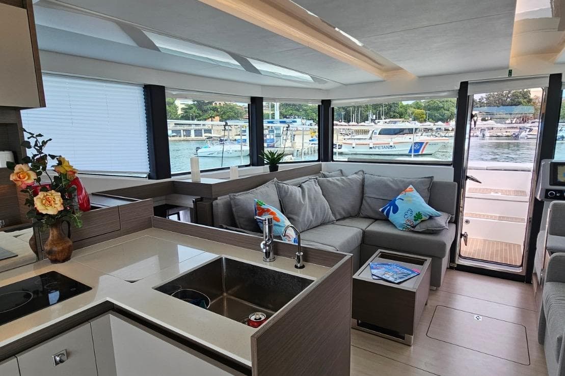 Luxurious interior of 2023 Leopard 40 Powercat yacht with modern kitchen and cozy seating area.