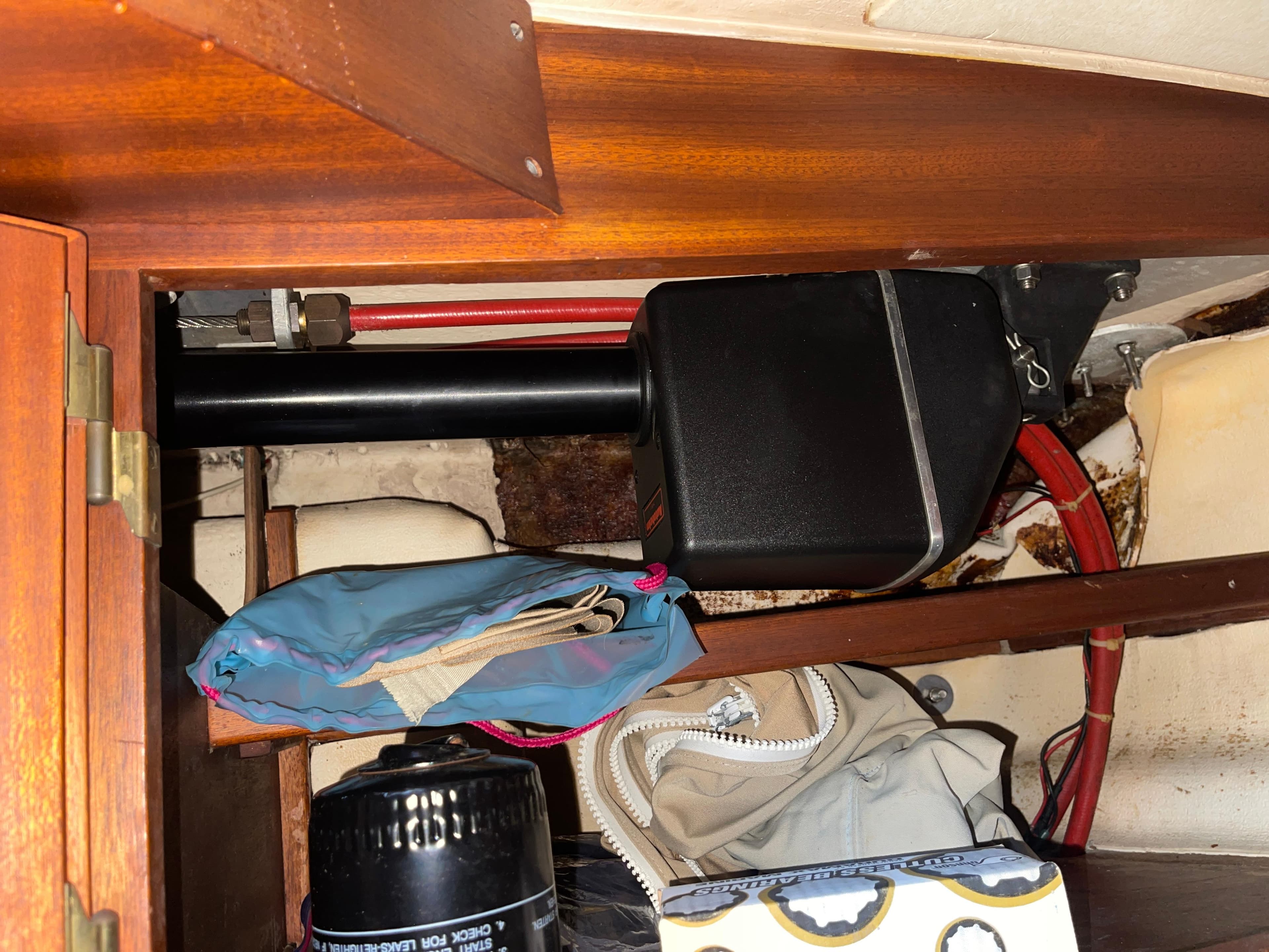 Storage compartment in a 1984 Hanseat 37 sailboat with various items and equipment.