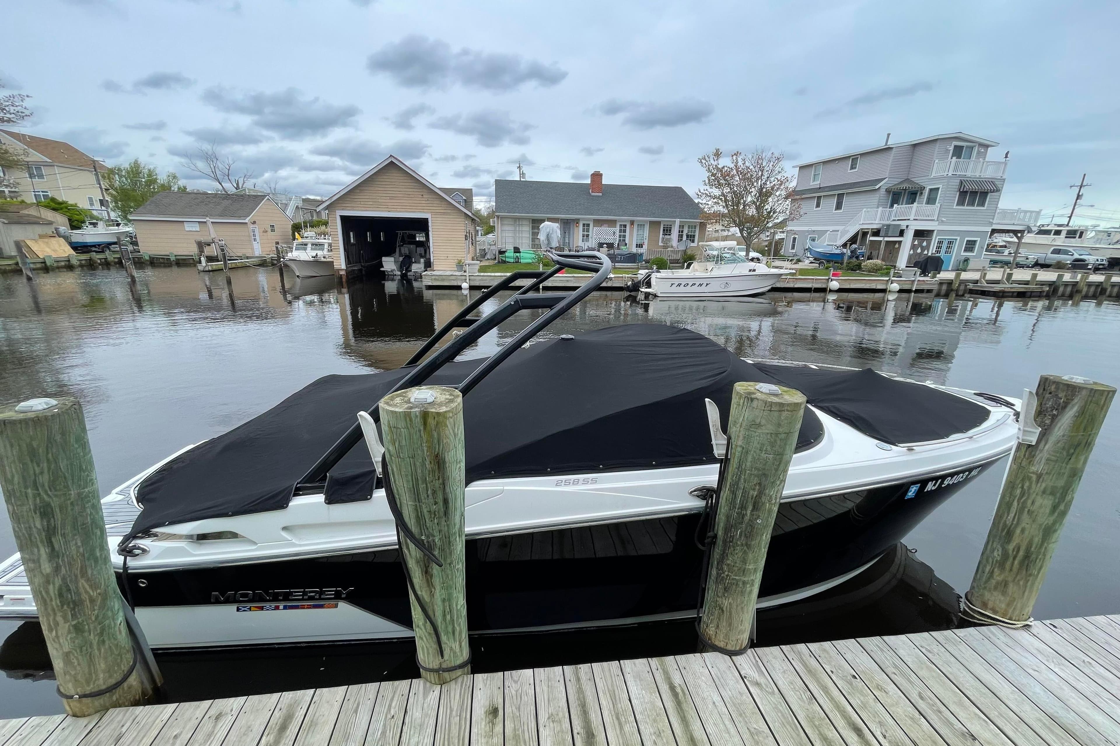 2018 Monterey 258 Super Sport boat docked at a marina with cover on.