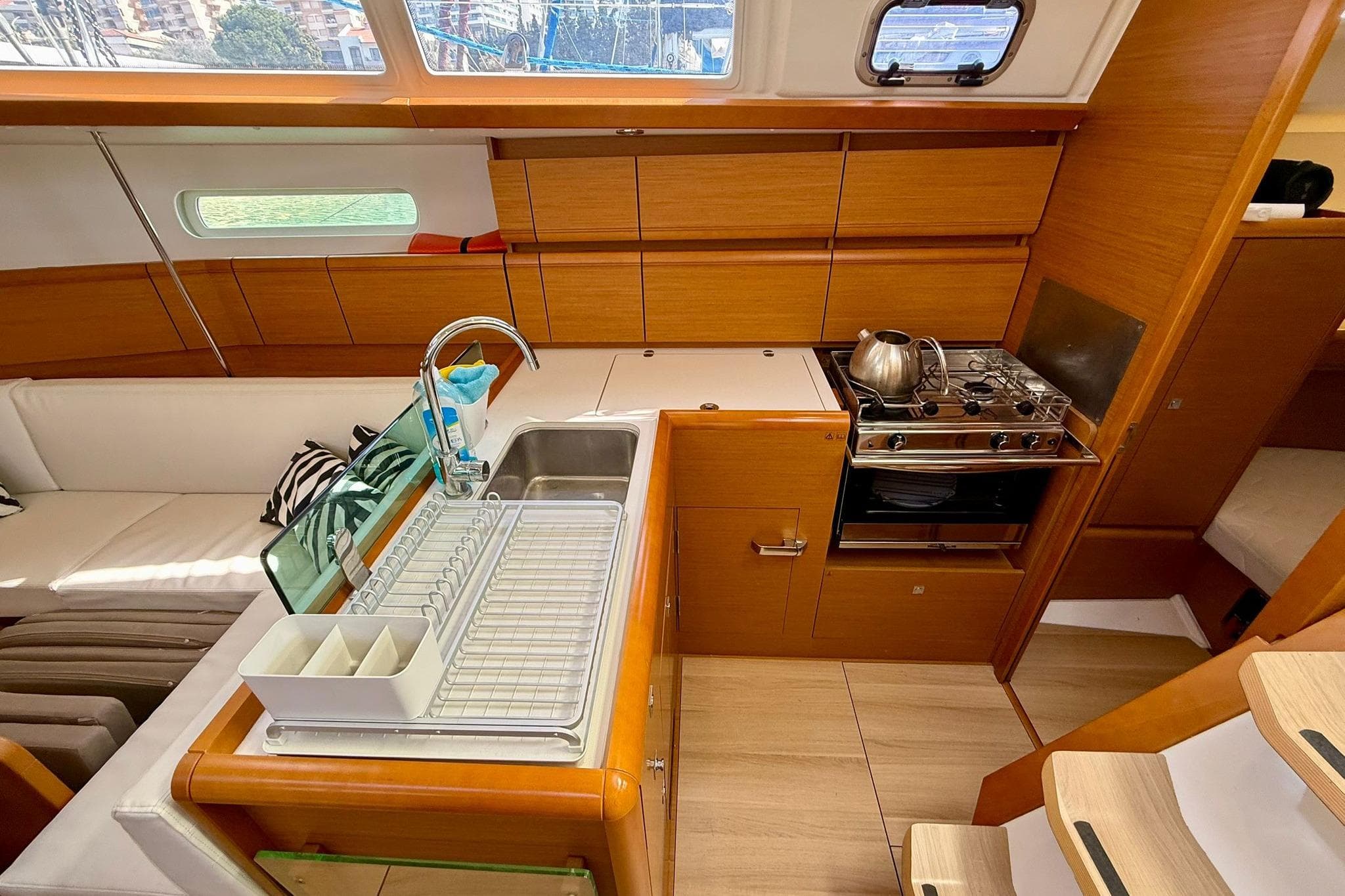 Interior of 2018 Jeanneau Sun Odyssey 389 yacht, featuring a modern kitchen and seating area.