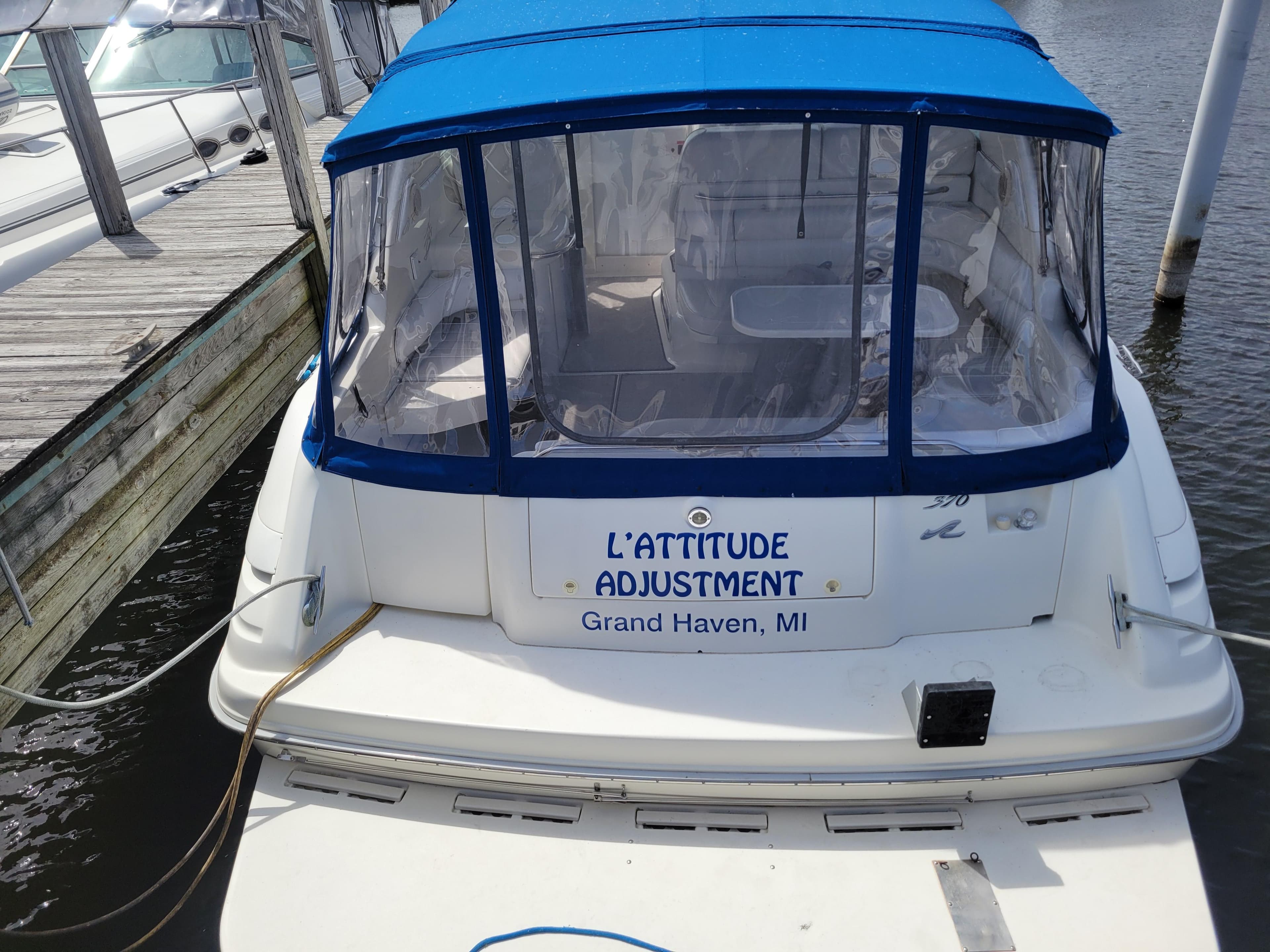 1995 Sea Ray 370 Sundancer boat with blue canopy, docked in Grand Haven, MI.