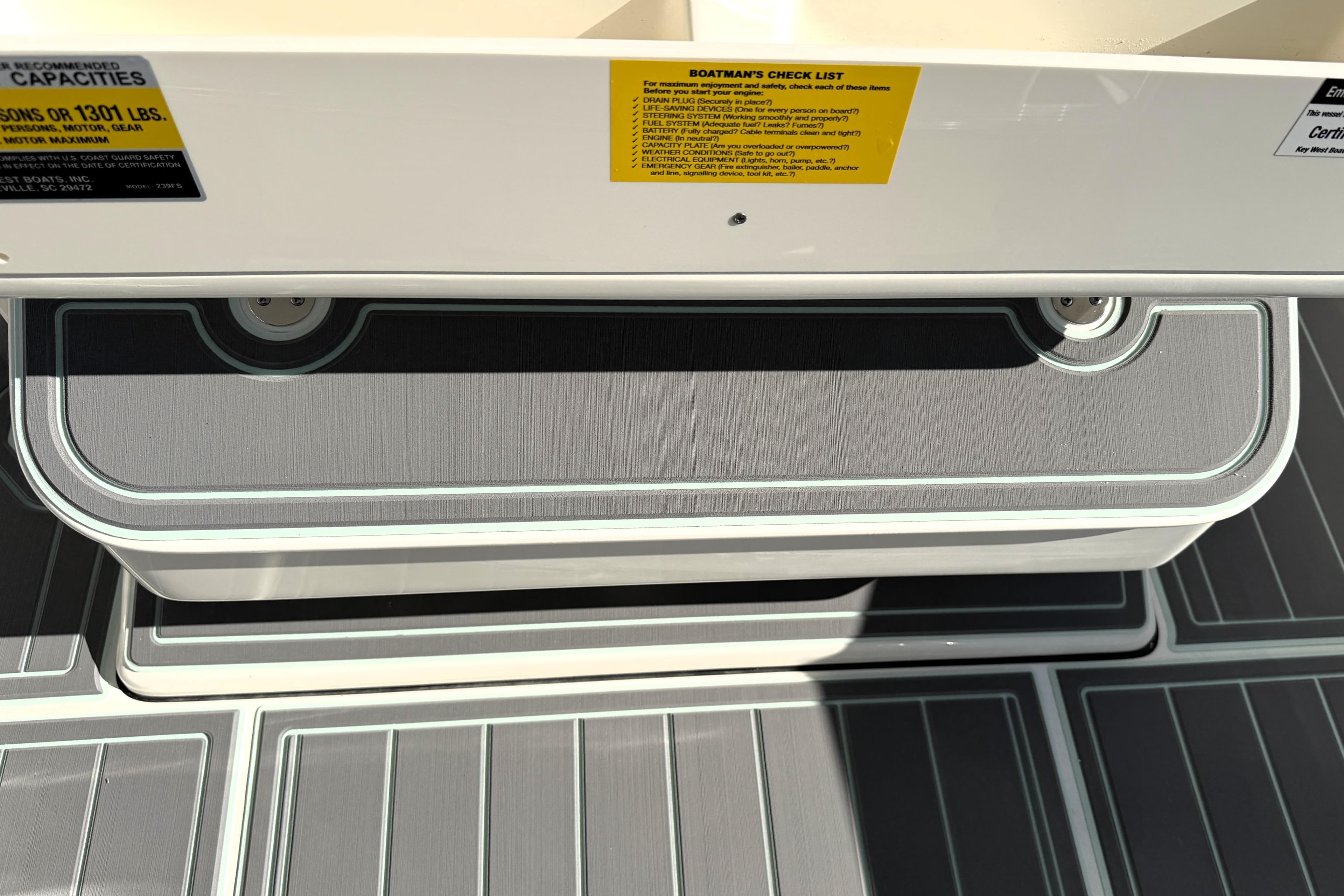 2025 Key West 239 FS boat interior with checklist and capacity labels.
