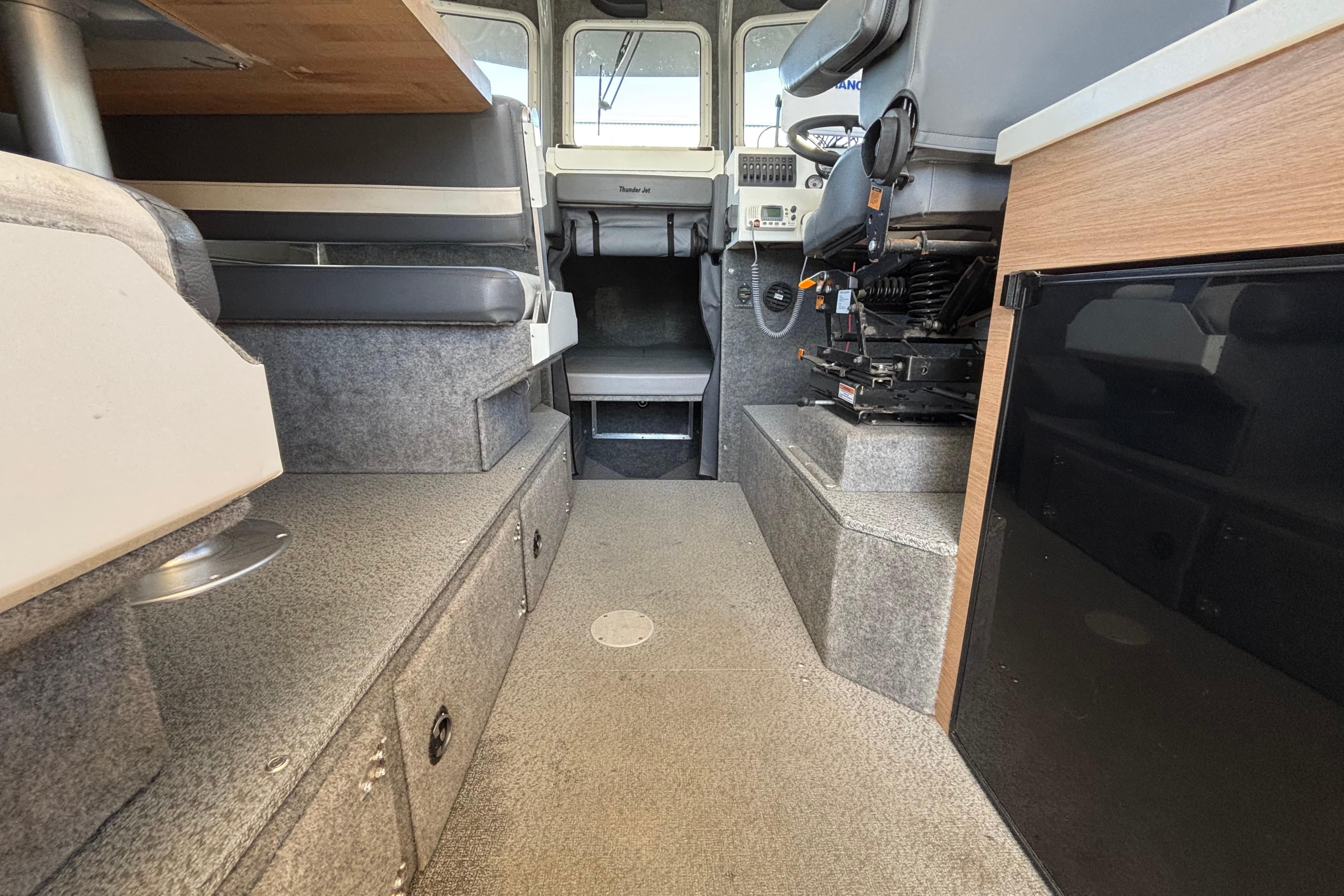 Interior of 2021 Thunder Jet 28 Pilot boat, featuring seating and control area.