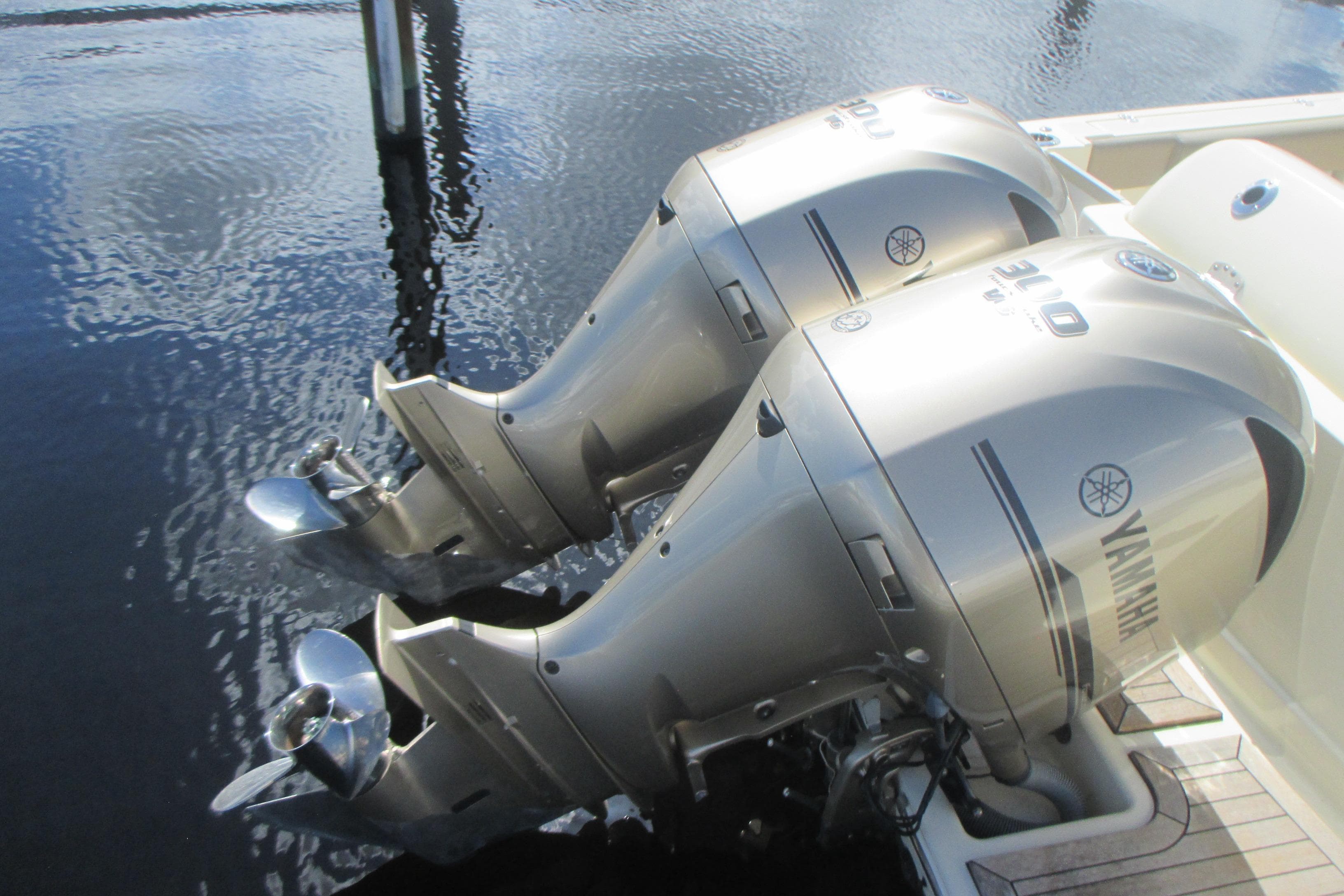 Twin Yamaha outboard engines on a 2019 Chris-Craft Catalina 30 boat, docked on water.