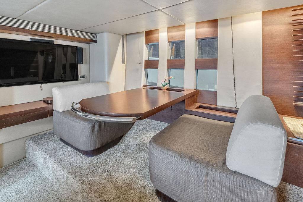 Luxurious interior of 2006 Azimut 68S yacht with modern seating and table.