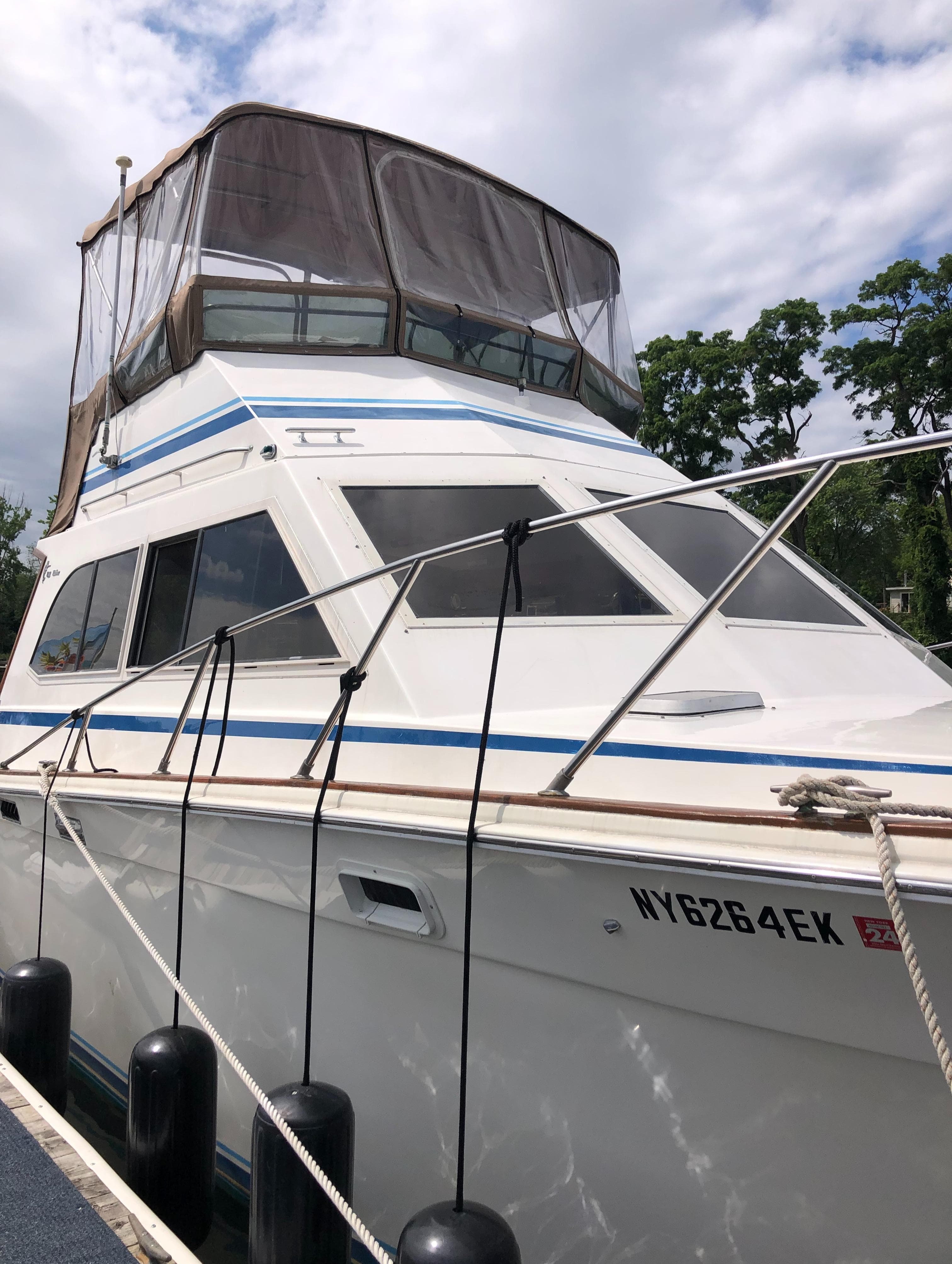 1987 Egg Harbor Convertible 37 boat docked, side view.