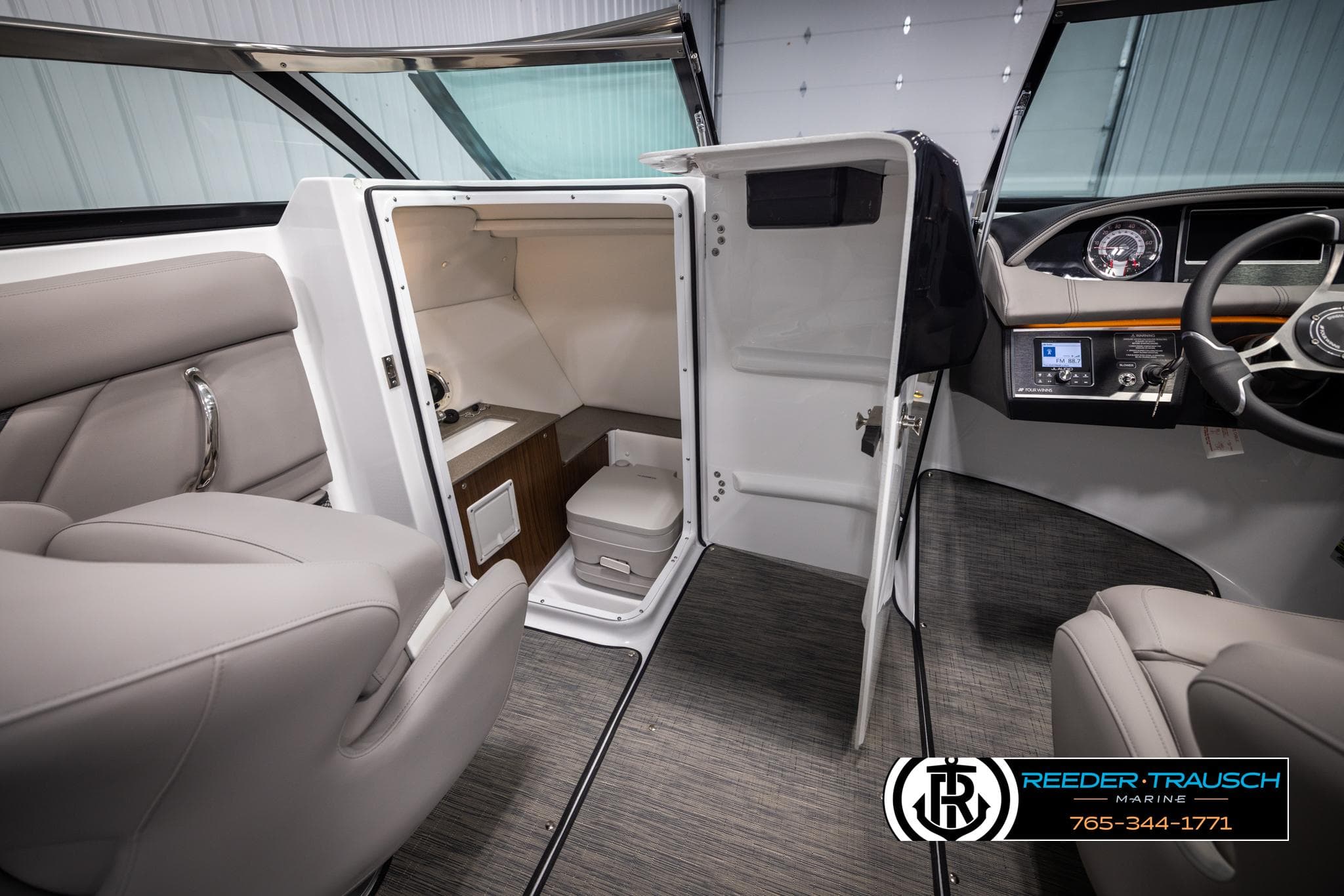 2025 Four Winns HD5 boat interior with seating, helm, and compact cabin area.