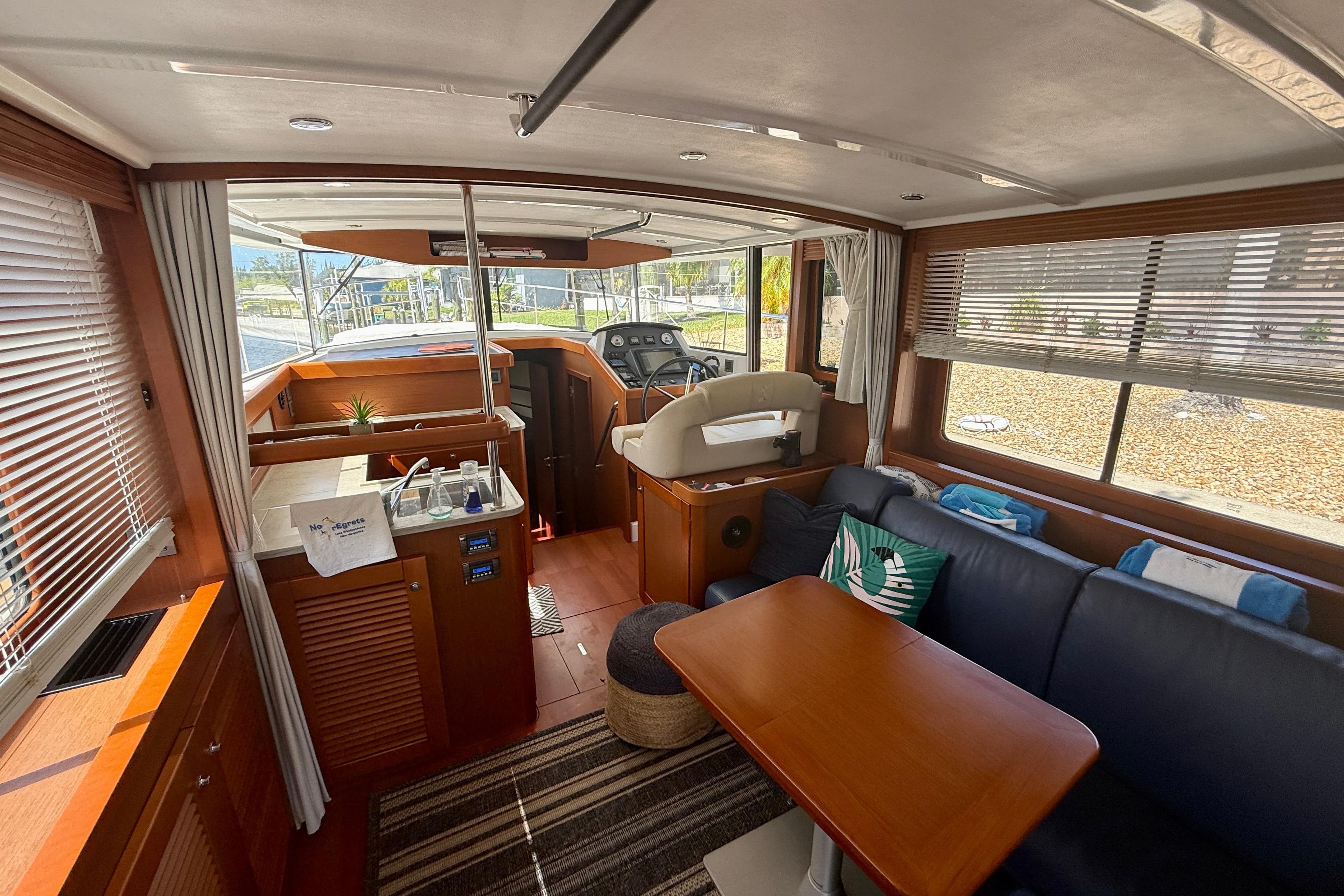 Interior of 2020 Beneteau Swift Trawler 44, featuring a cozy seating area and helm station.