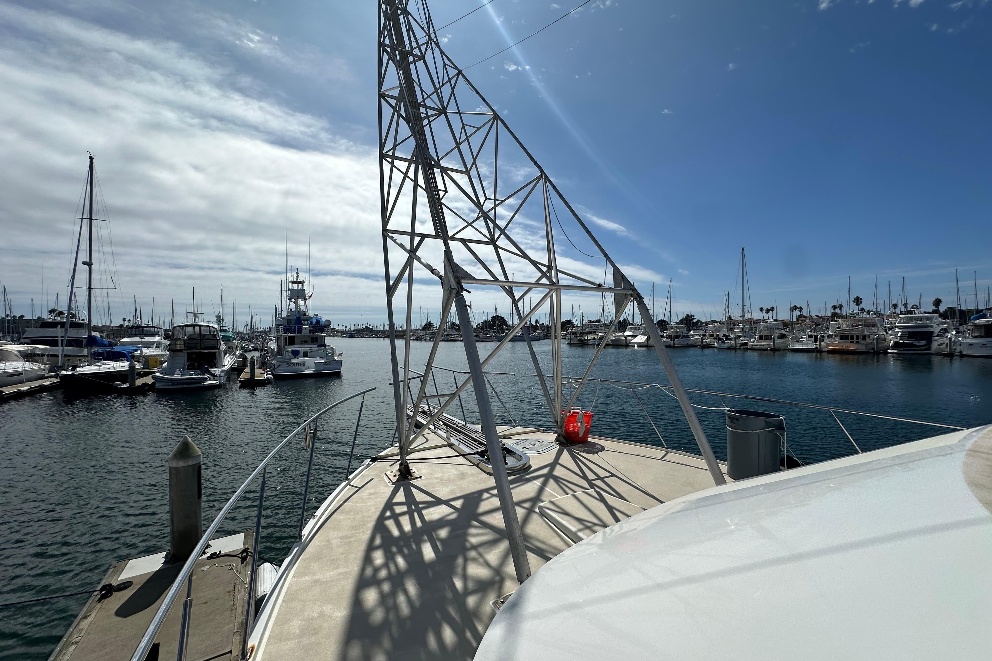 1973 Elliott Yachtfisher docked in a marina under a clear blue sky.