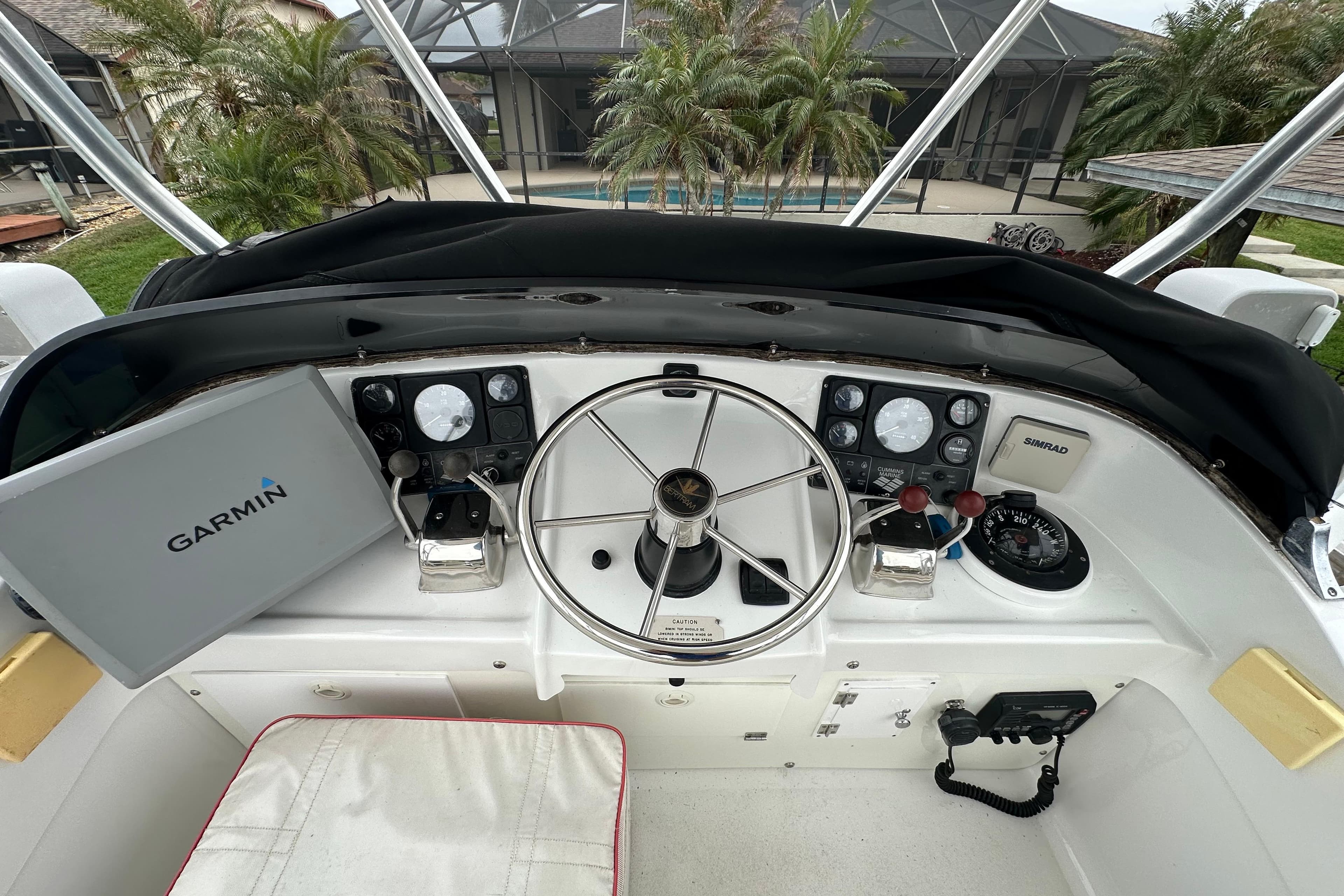 1975 Bertram 31 boat helm with Garmin navigation and Simrad equipment.