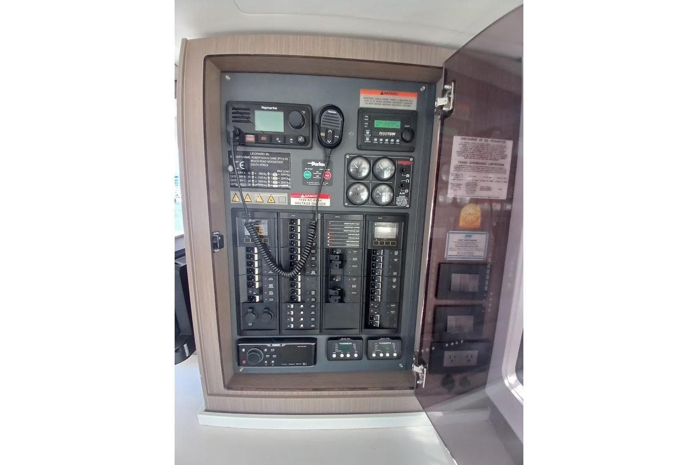 Electrical control panel inside 2022 Leopard 45 yacht, featuring various switches and gauges.