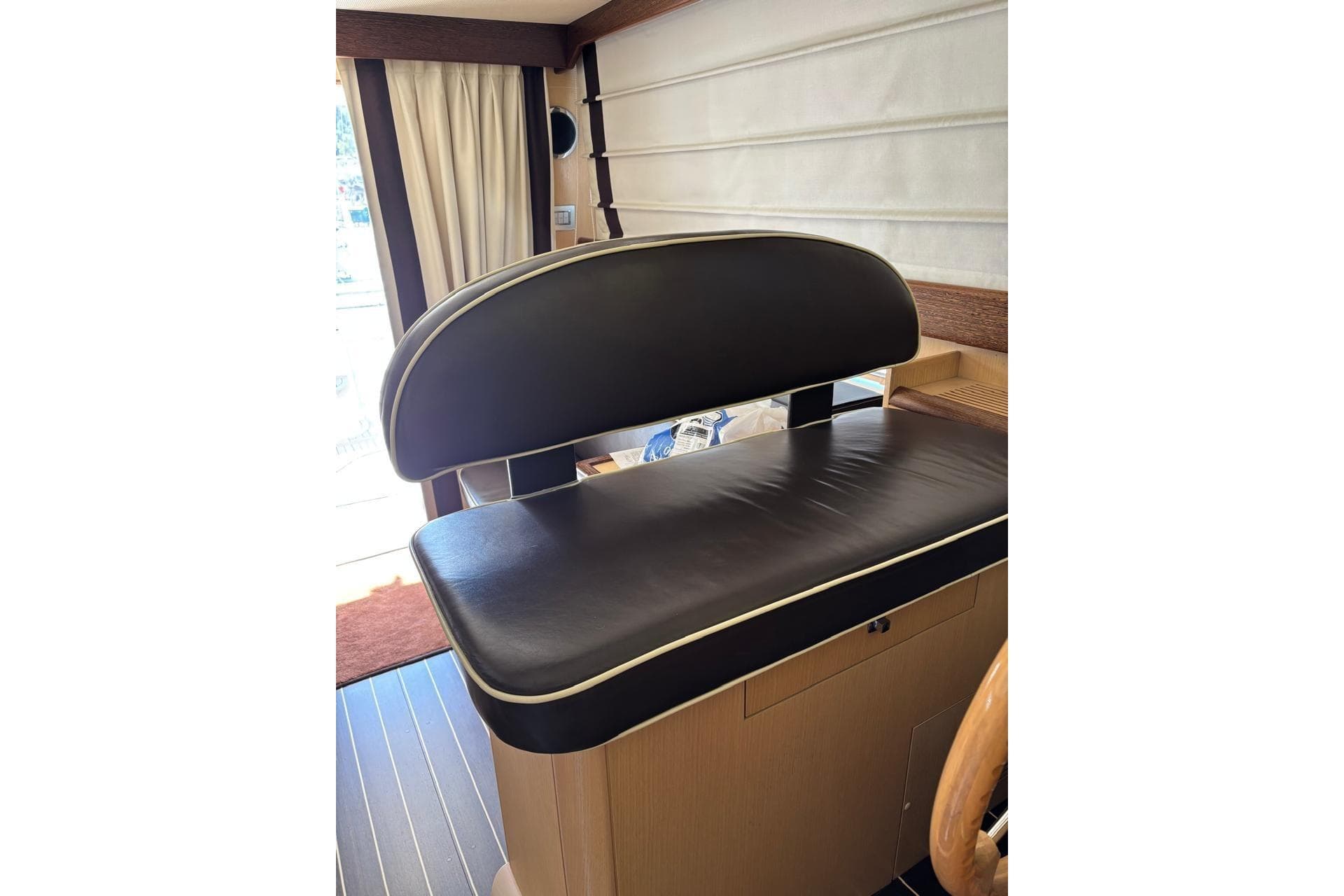 Luxurious black leather seating on 2010 Portofino 47 Fly yacht interior.