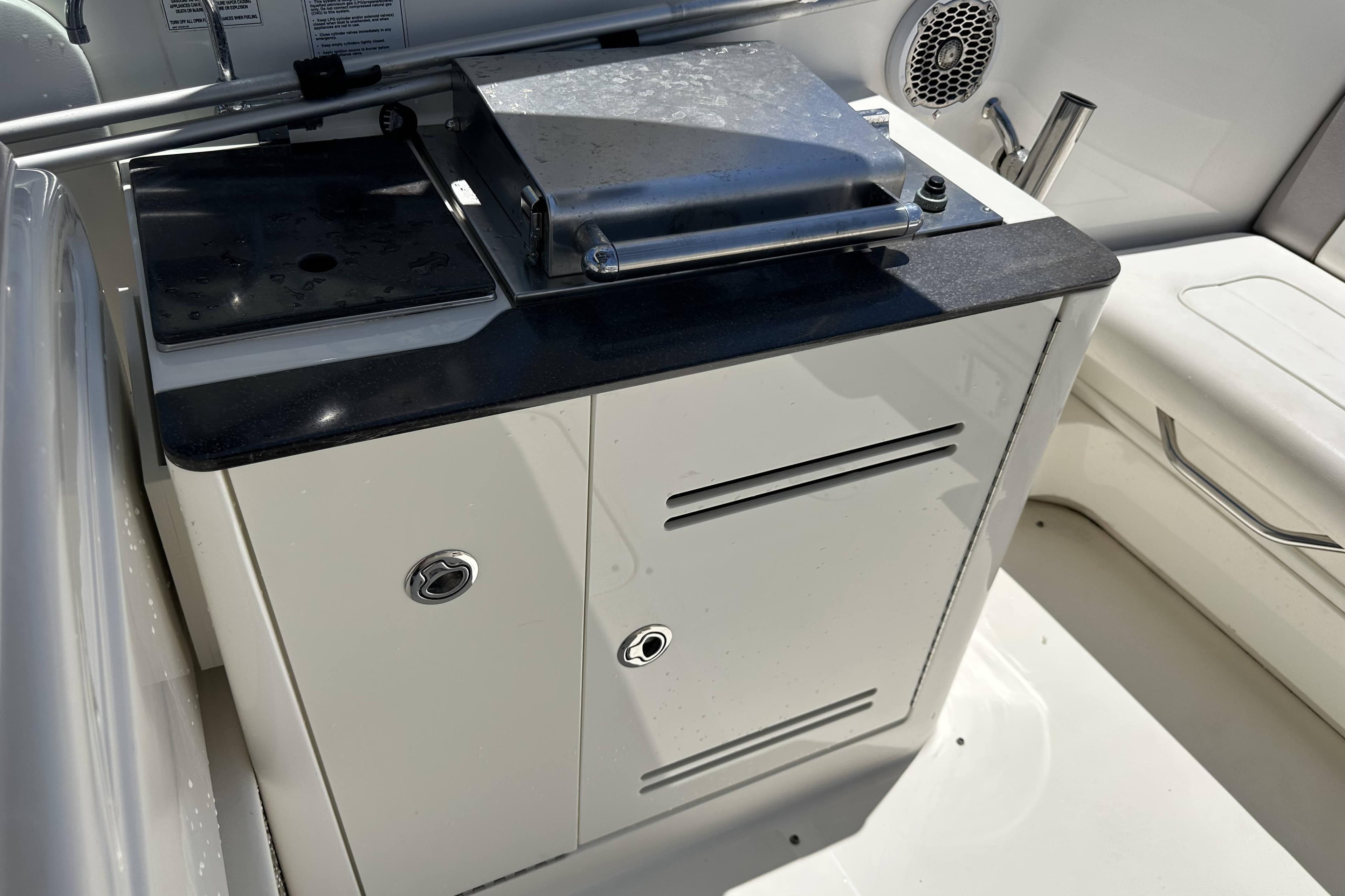 2012 Sea Ray 300 SLX boat interior with built-in grill and storage cabinet.