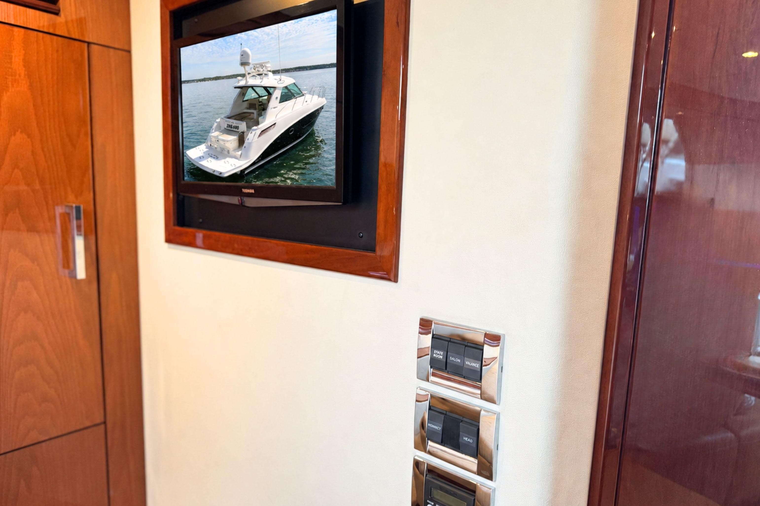 Interior view of a 2013 Sea Ray 450 Sundancer yacht with a wall-mounted TV.
