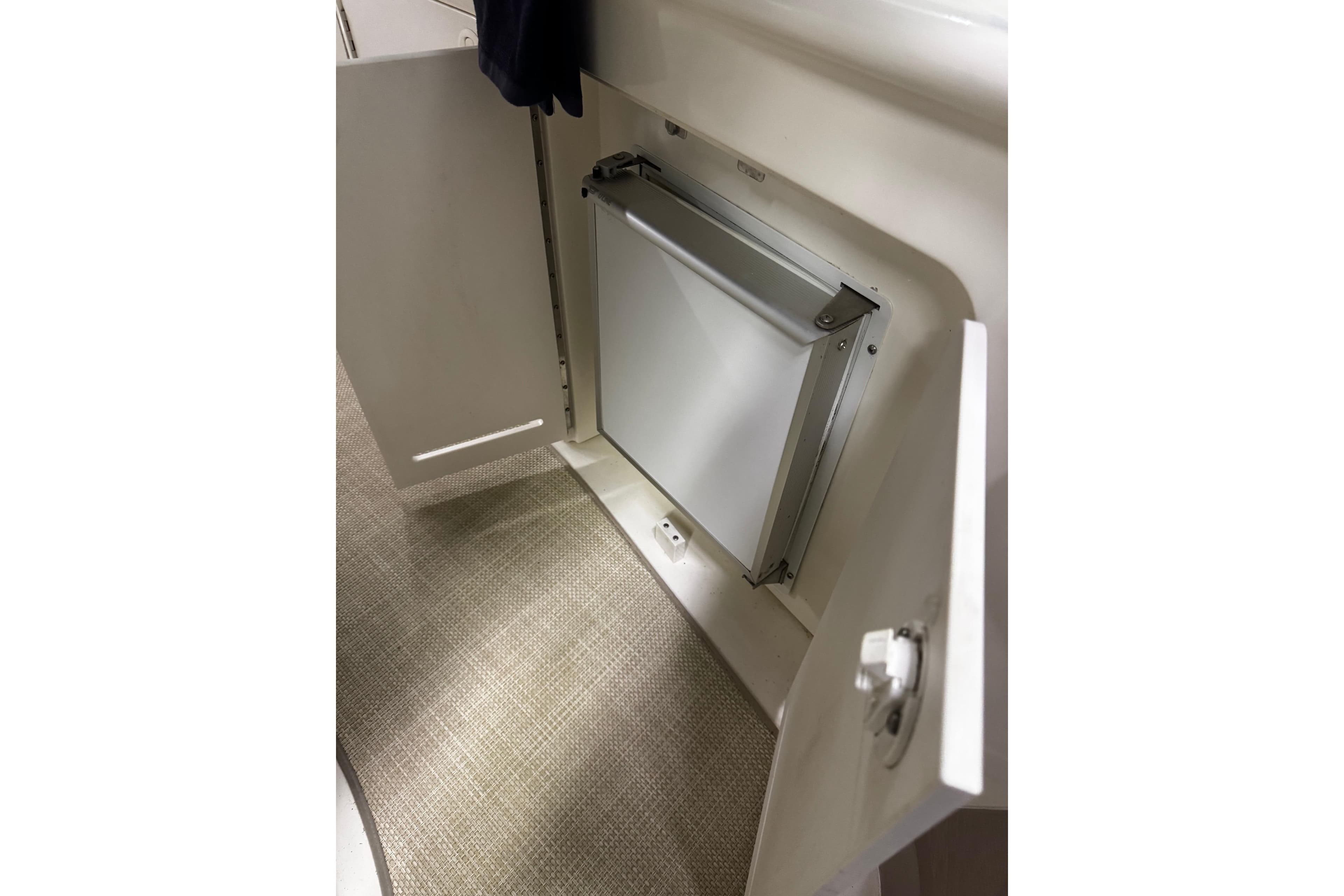 Open cabinet with built-in trash bin on 1999 Sea Ray 340 Sundancer boat.