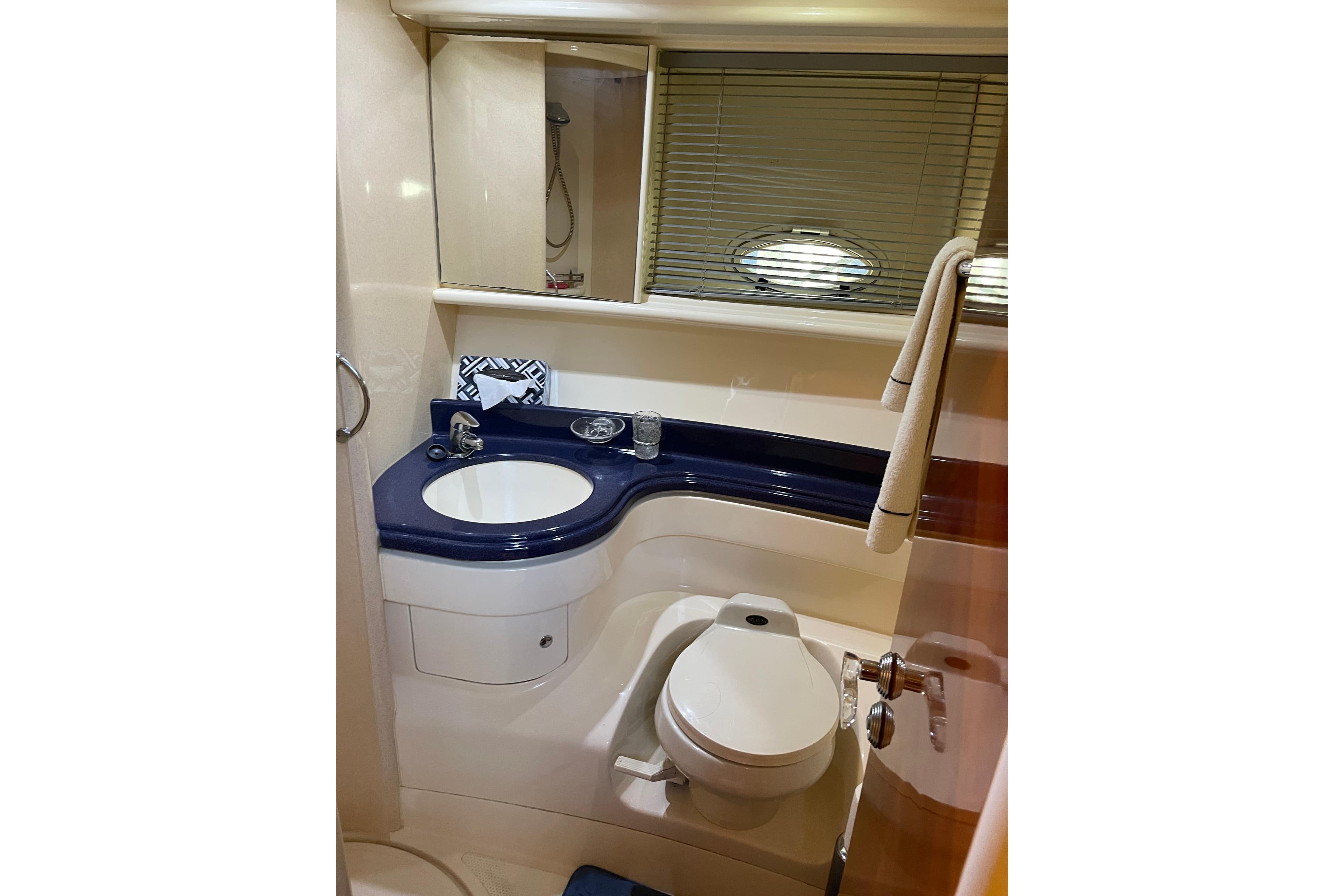 Luxurious bathroom in 2000 Azimut 46 Flybridge yacht, featuring modern fixtures and elegant design.