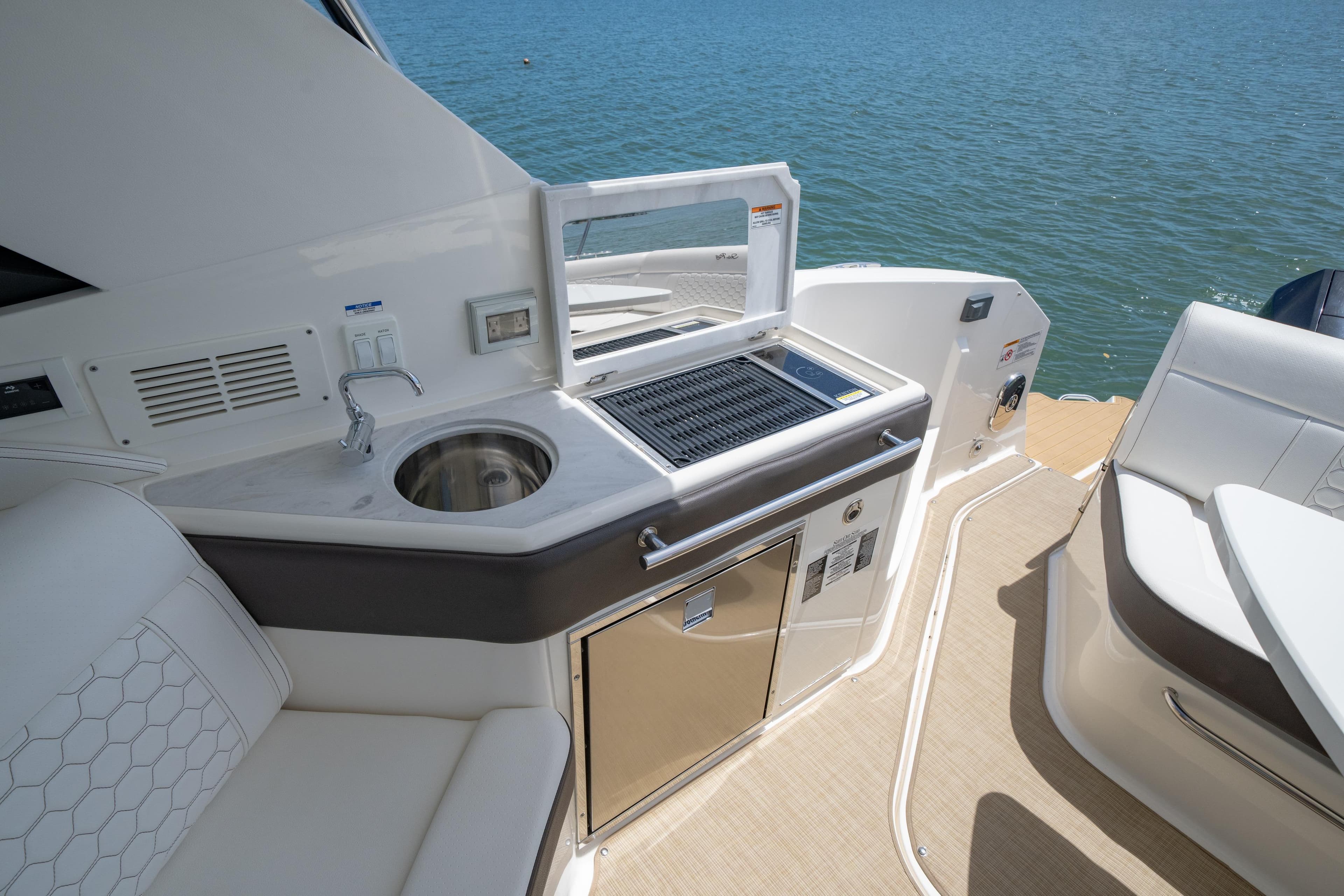 Luxurious 2024 Sea Ray Sundancer 320 Outboard yacht with sleek outdoor kitchenette.