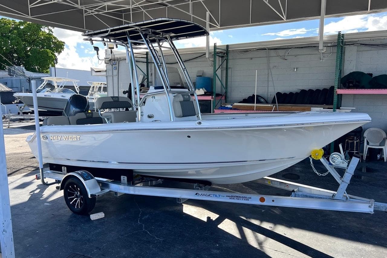 2026 Key West 189 FS boat on trailer under canopy, parked in a marina.