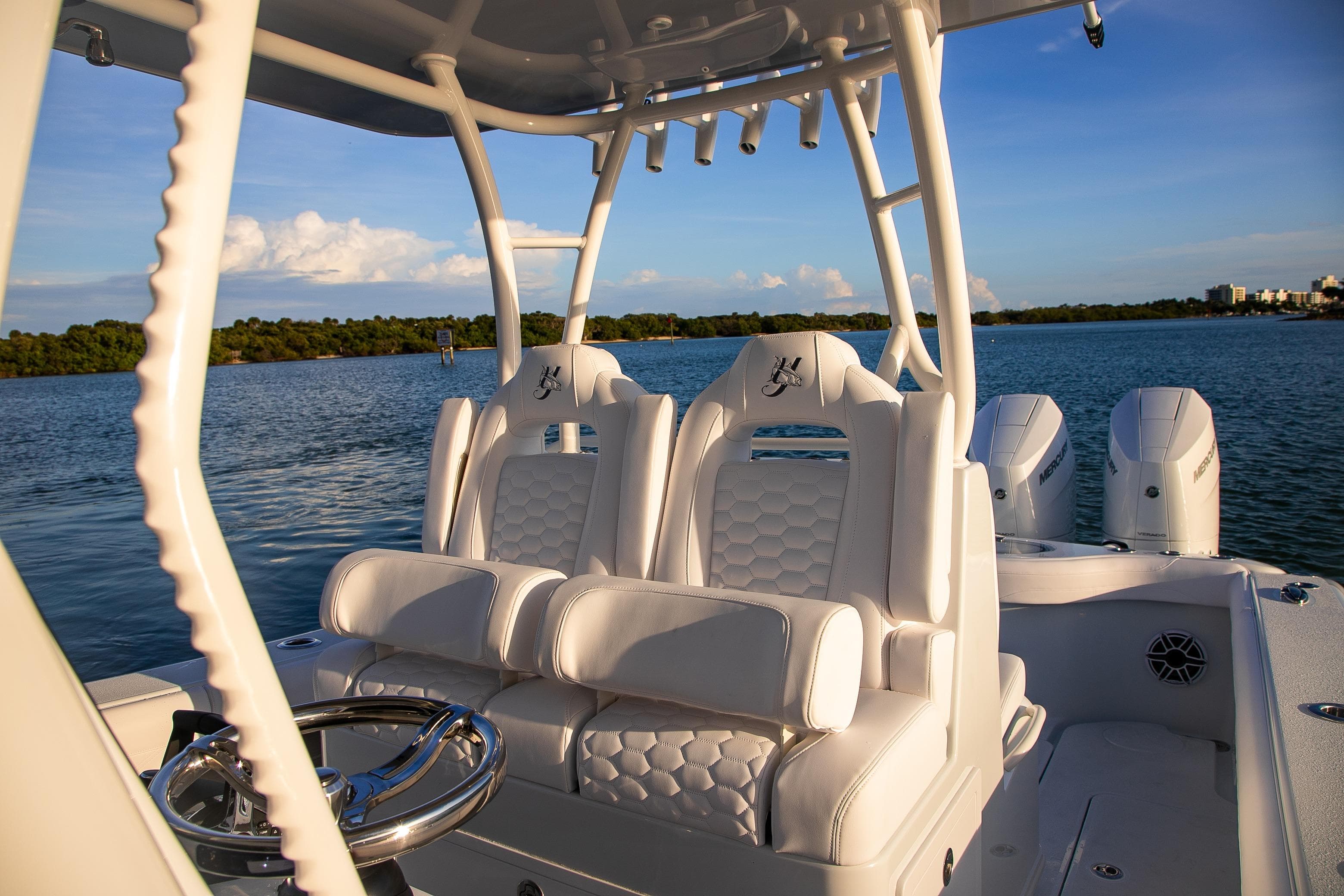 2026 Yellowfin 36 Offshore boat interior with luxurious seating and ocean backdrop.