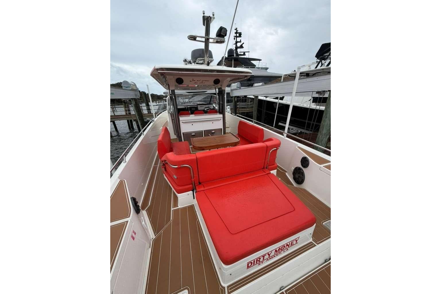 2021 Nimbus T-11 boat with red seating, docked at marina.