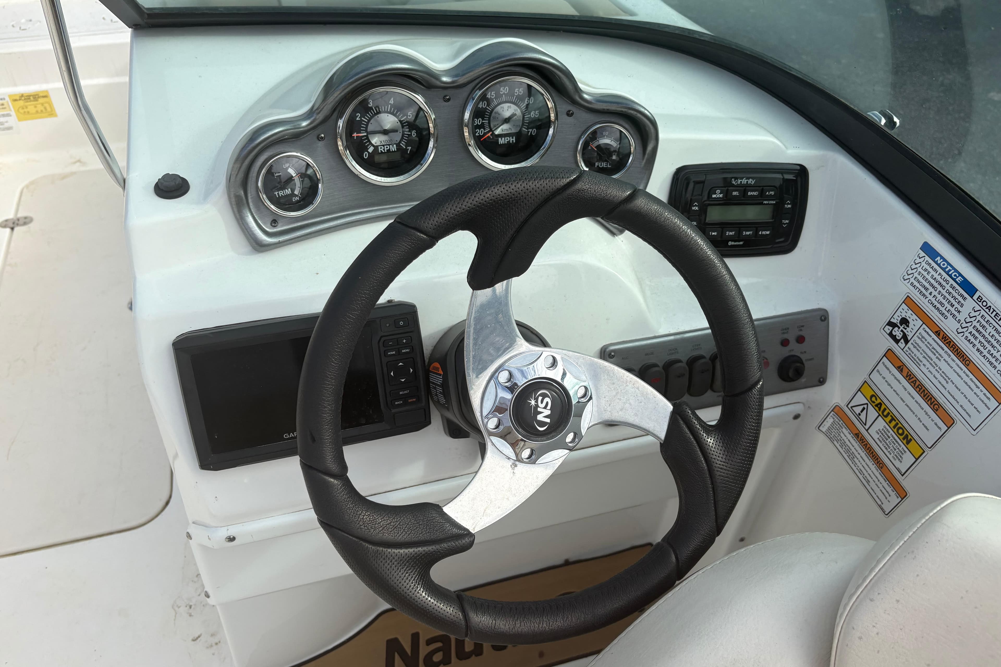 2022 NauticStar 203 DC boat dashboard with steering wheel and gauges.