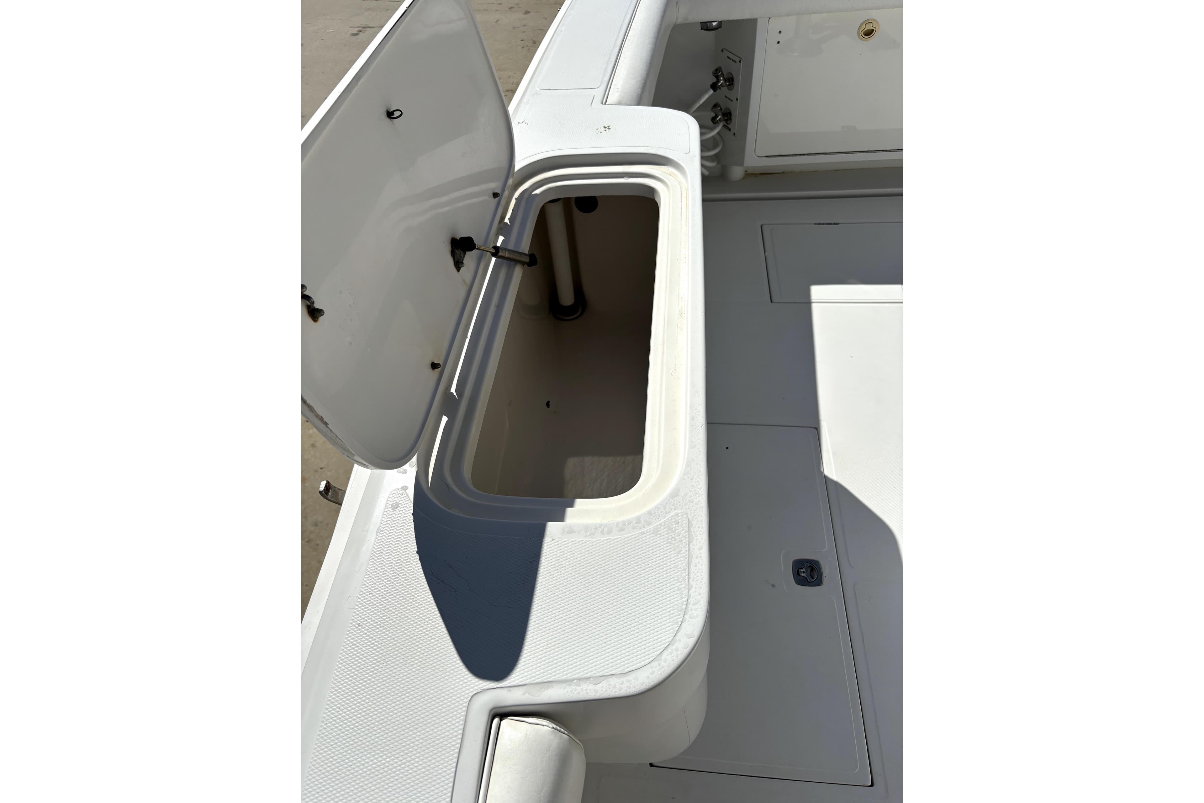 Open storage compartment on a 2004 Jupiter 35 Convertible boat deck.