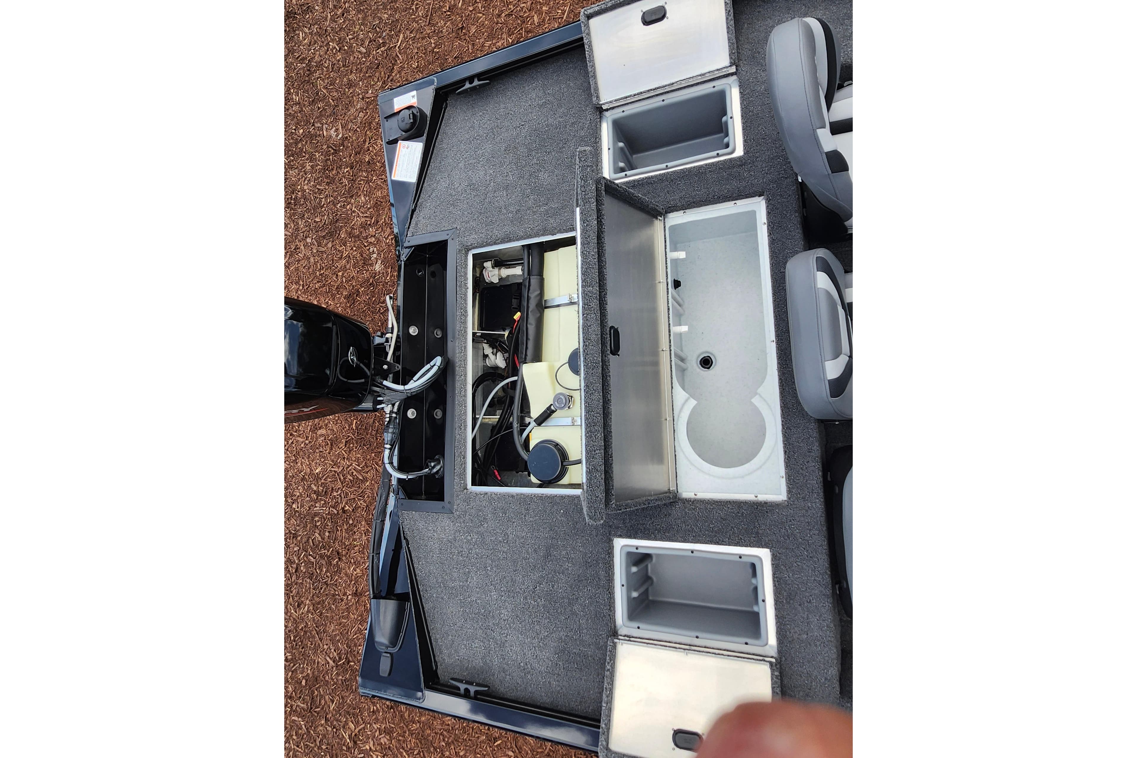 2026 Lowe Stinger 175C boat interior with open storage compartments and seating.