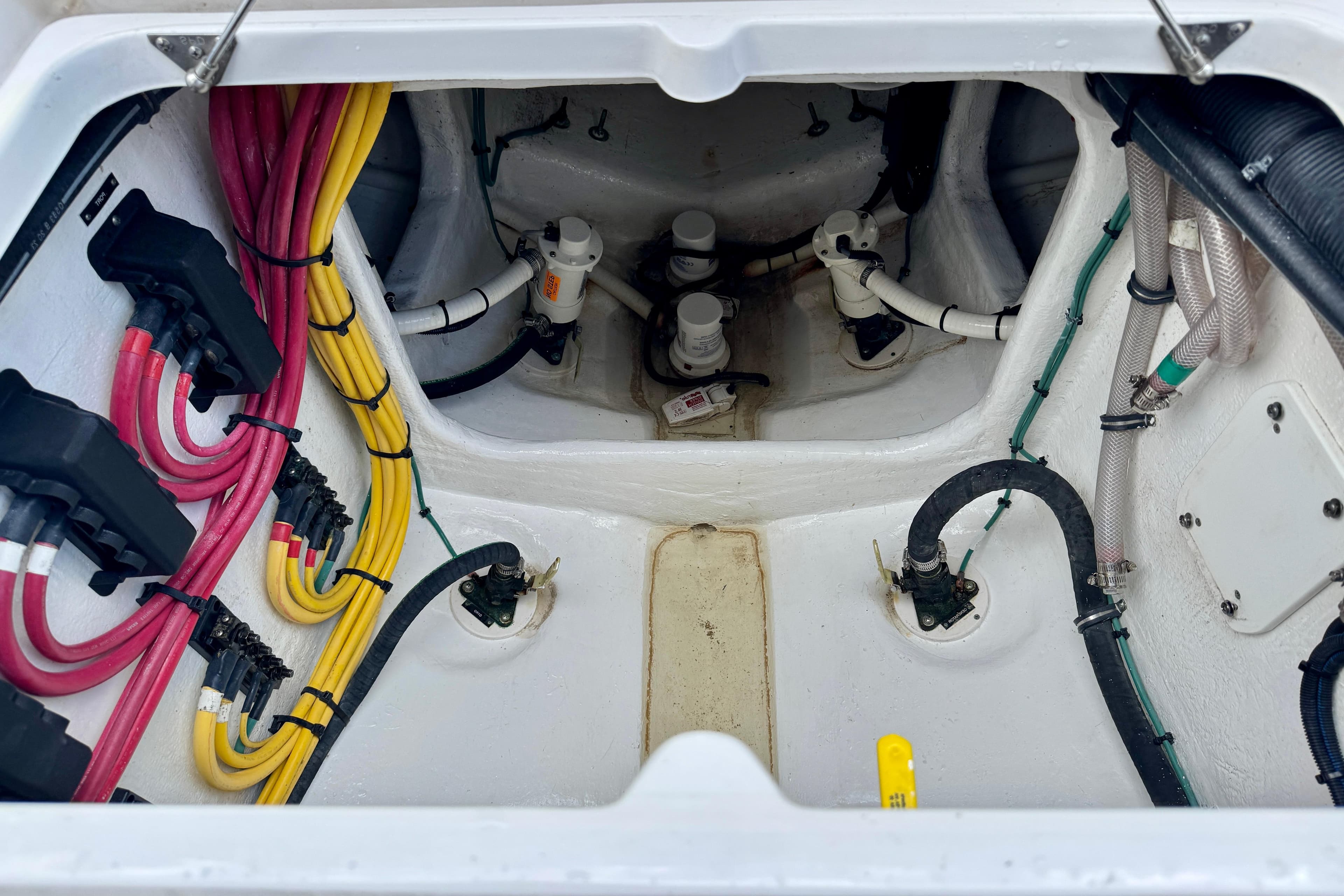 Engine compartment of 2024 Intrepid 427 Nomad SE with colorful wiring and hoses.