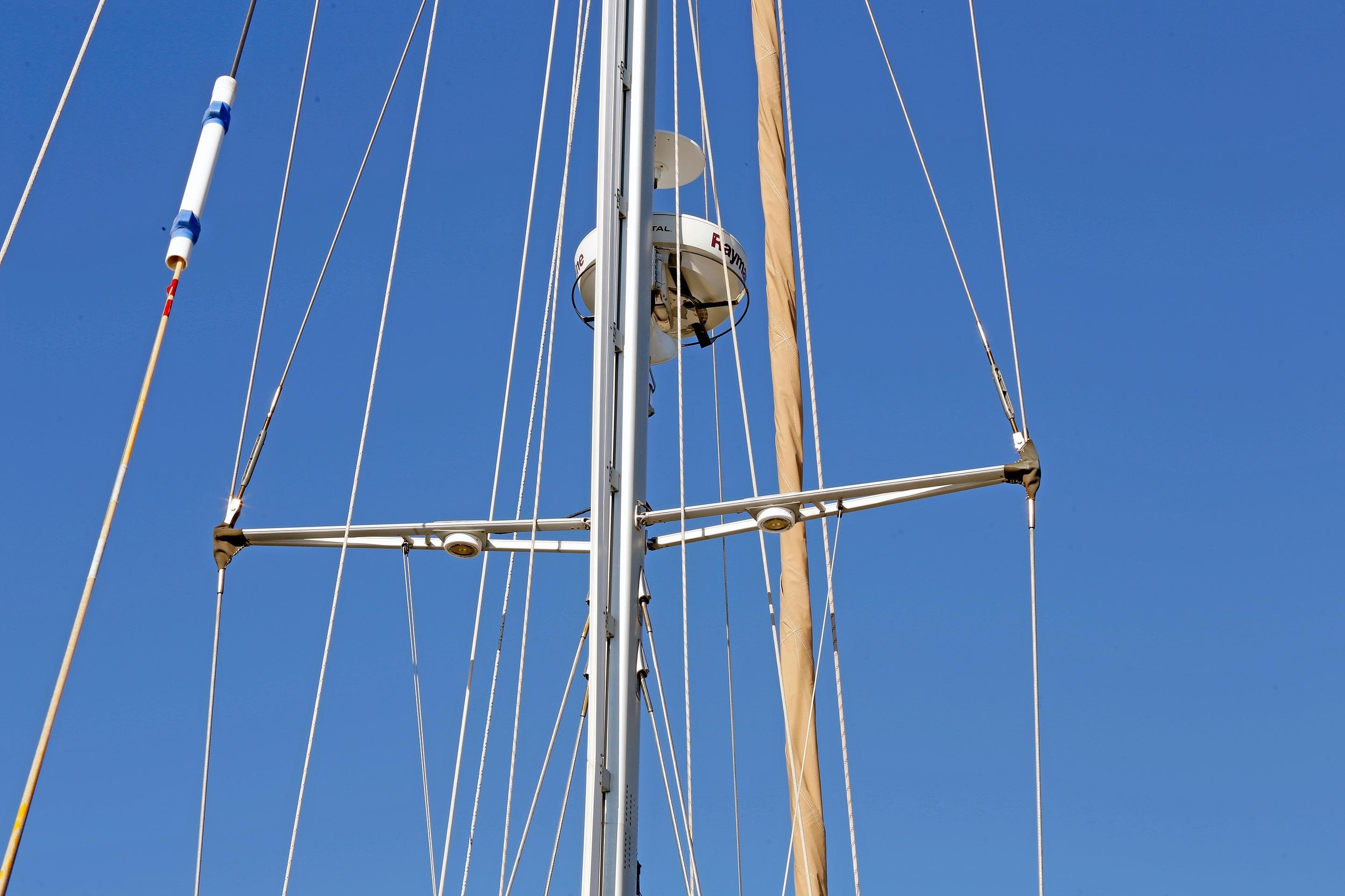 Mast and rigging of 2012 Hylas 49CC sailboat against clear blue sky.